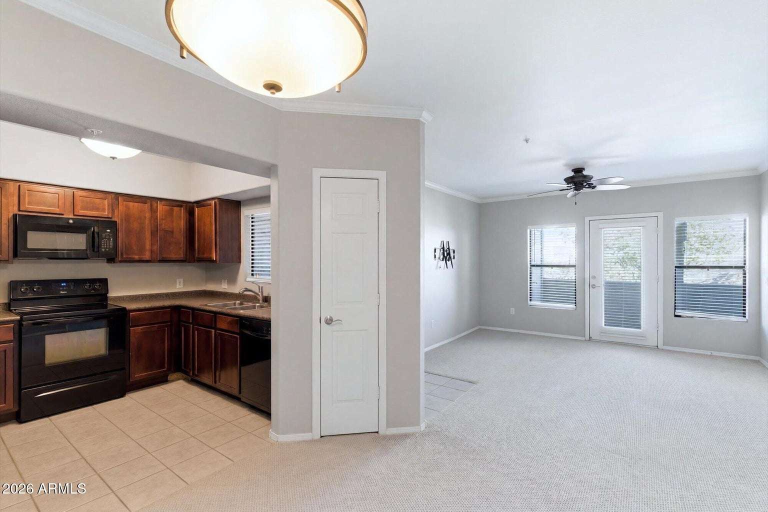 12 of 32. This bright interior showcases the seamless connection between the kitchen and living room, offering an ideal layout for entertaining, relaxing, and everyday living with plenty of natural light.