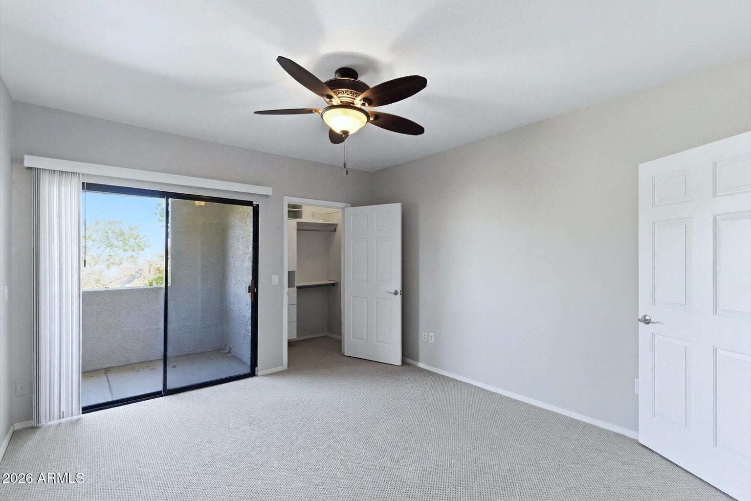 17 of 32. This spacious bedroom offers balcony access, a walk-in closet, ceiling fan, and neutral finishes that create a bright, comfortable, and move-in-ready retreat.