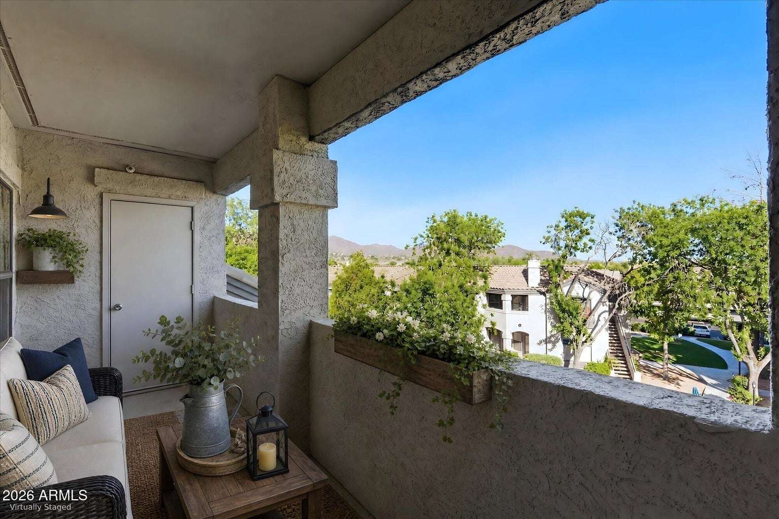 22 of 32. Virtually staged to illustrate its possibilities, this covered balcony offers a comfortable outdoor retreat with peaceful views of the surrounding Scottsdale community and nearby mountains.