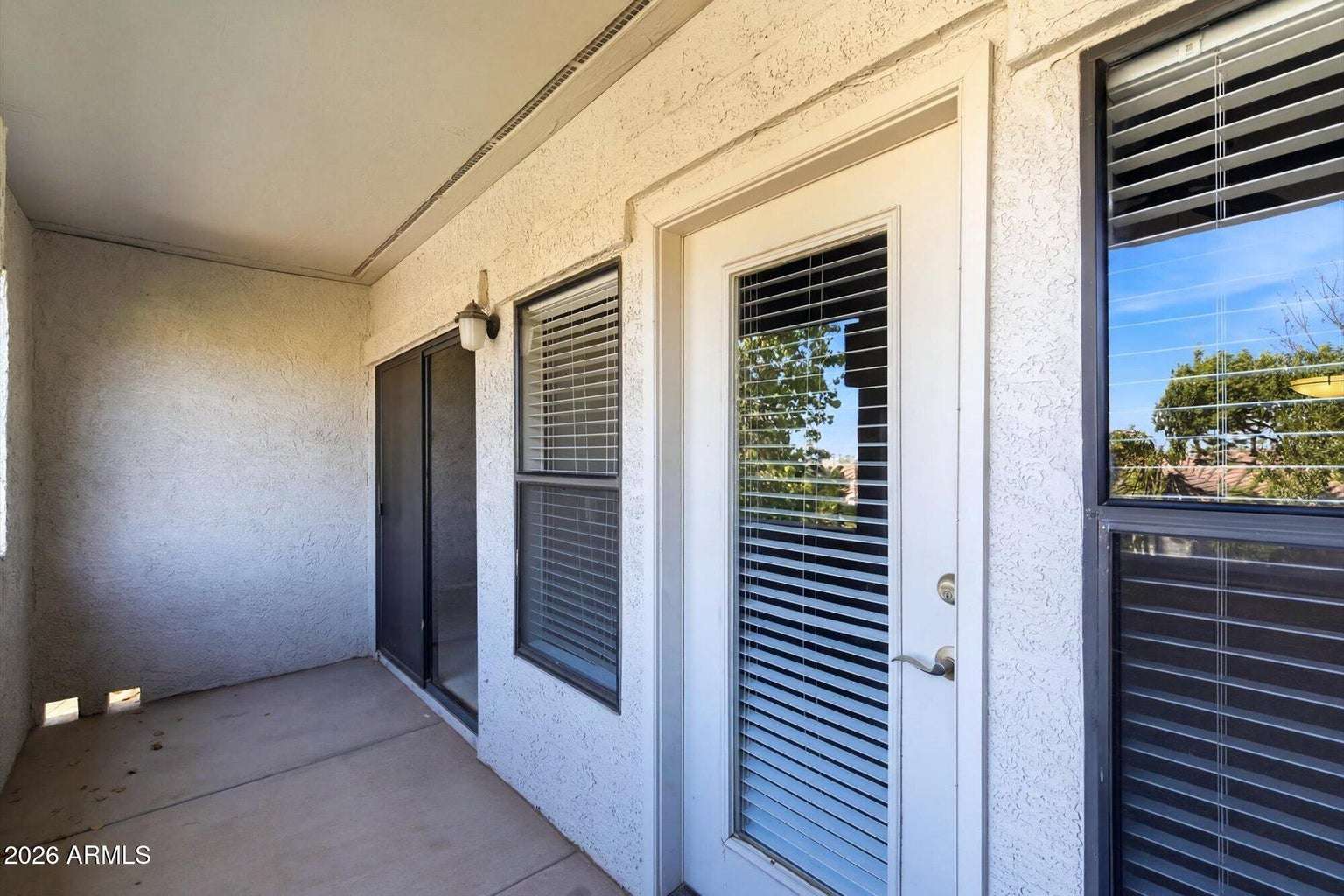 24 of 32. Enjoy generous outdoor living on this covered balcony with convenient access from both the primary bedroom and living room, providing an inviting space to relax in Scottsdale.