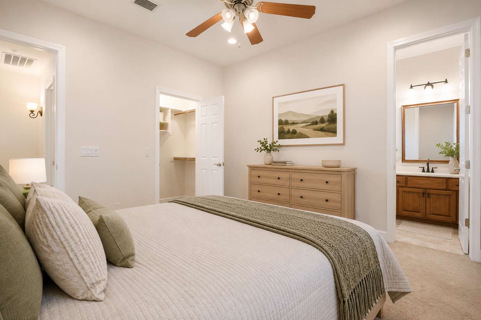 41 of 72. The staged primary bedroom highlights generous proportions, plush carpeting, ceiling fan, walk-in closet access, and an adjoining private bathroom for everyday comfort and convenience.