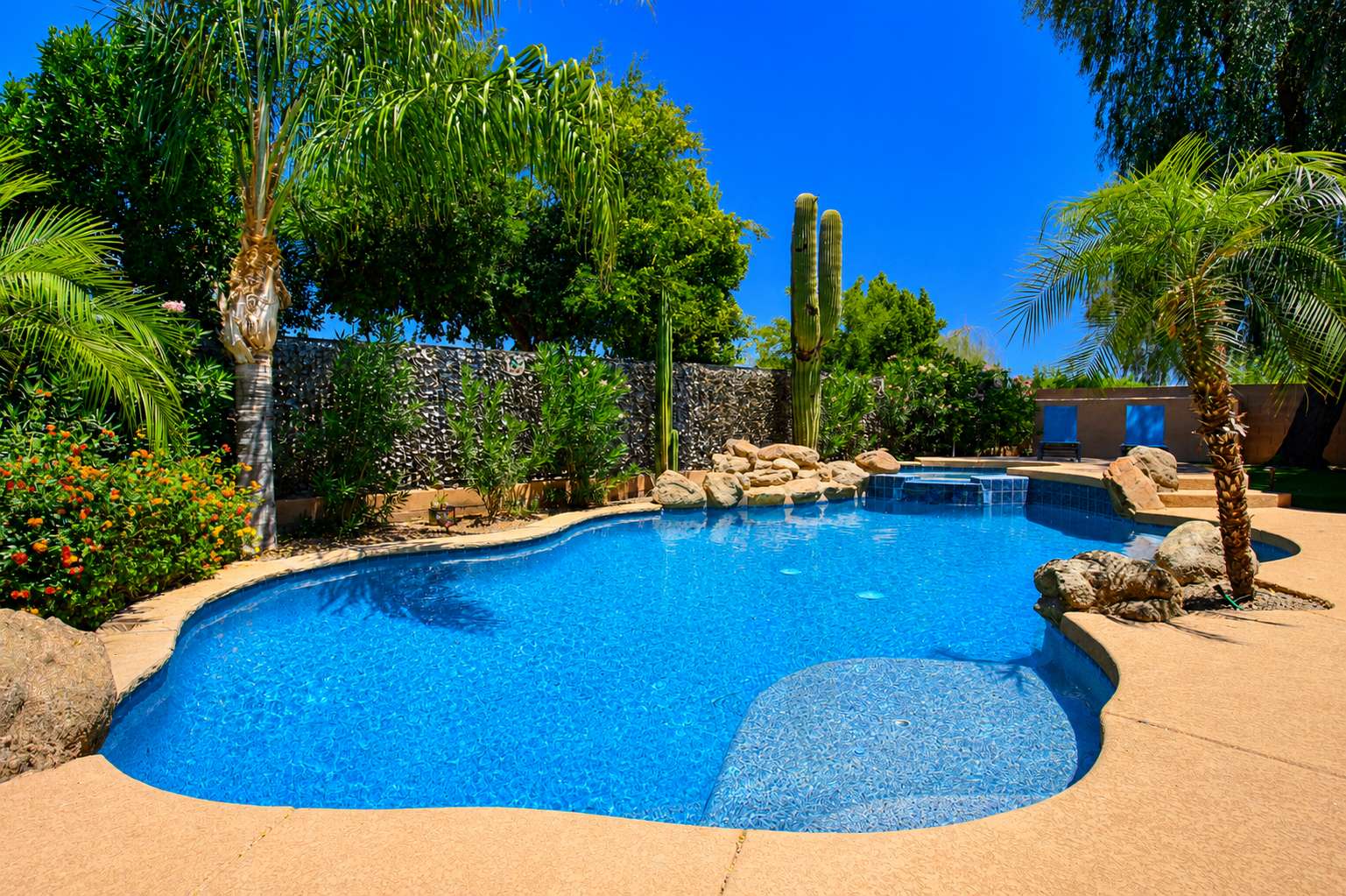 58 of 72. This inviting backyard combines a custom pool, spa, natural rock waterfall, mature landscaping, and expansive outdoor space to create a true Scottsdale retreat.