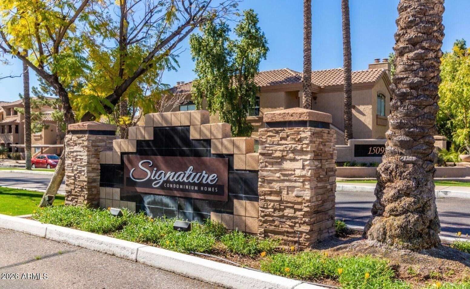 25 of 32. The attractive monument sign welcomes residents and guests to Signature Condominium Homes, a beautifully maintained Scottsdale community offering resort-inspired amenities and convenient living.