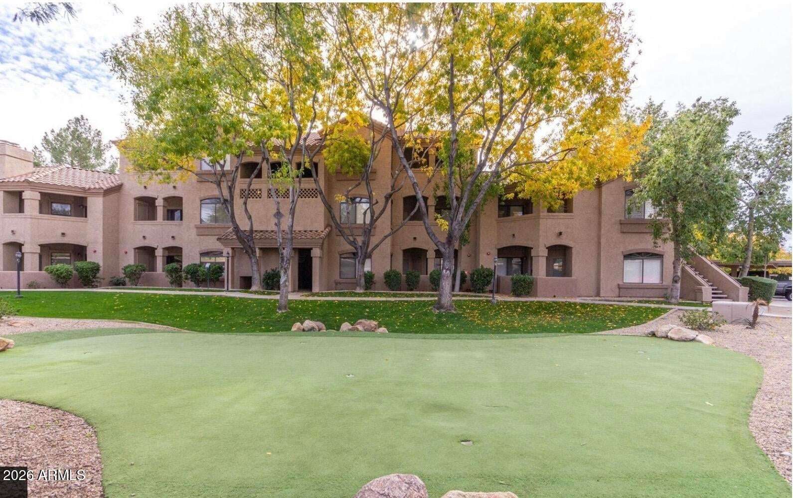 27 of 32. Mature trees, manicured lawns, and attractive architecture create a welcoming atmosphere throughout this well-maintained Scottsdale condominium community.