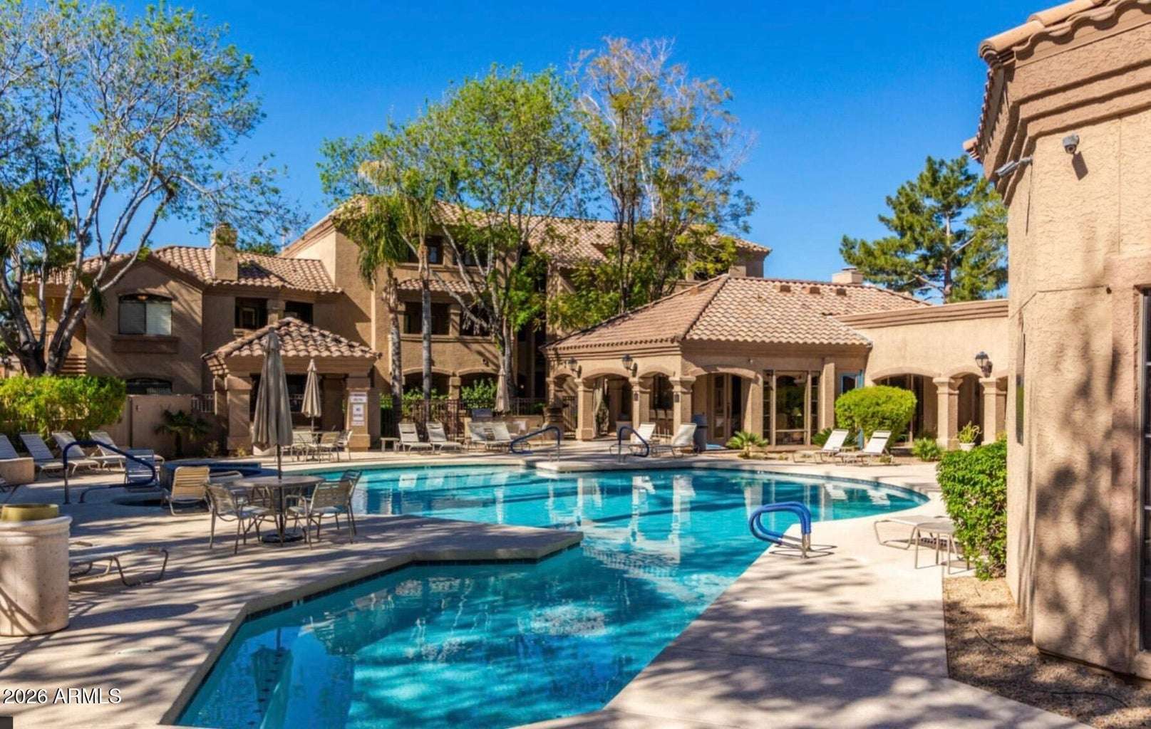 26 of 32. The inviting community pool offers a resort-inspired setting with expansive sundecks, lounge chairs, mature landscaping, and relaxing common areas for residents to enjoy.
