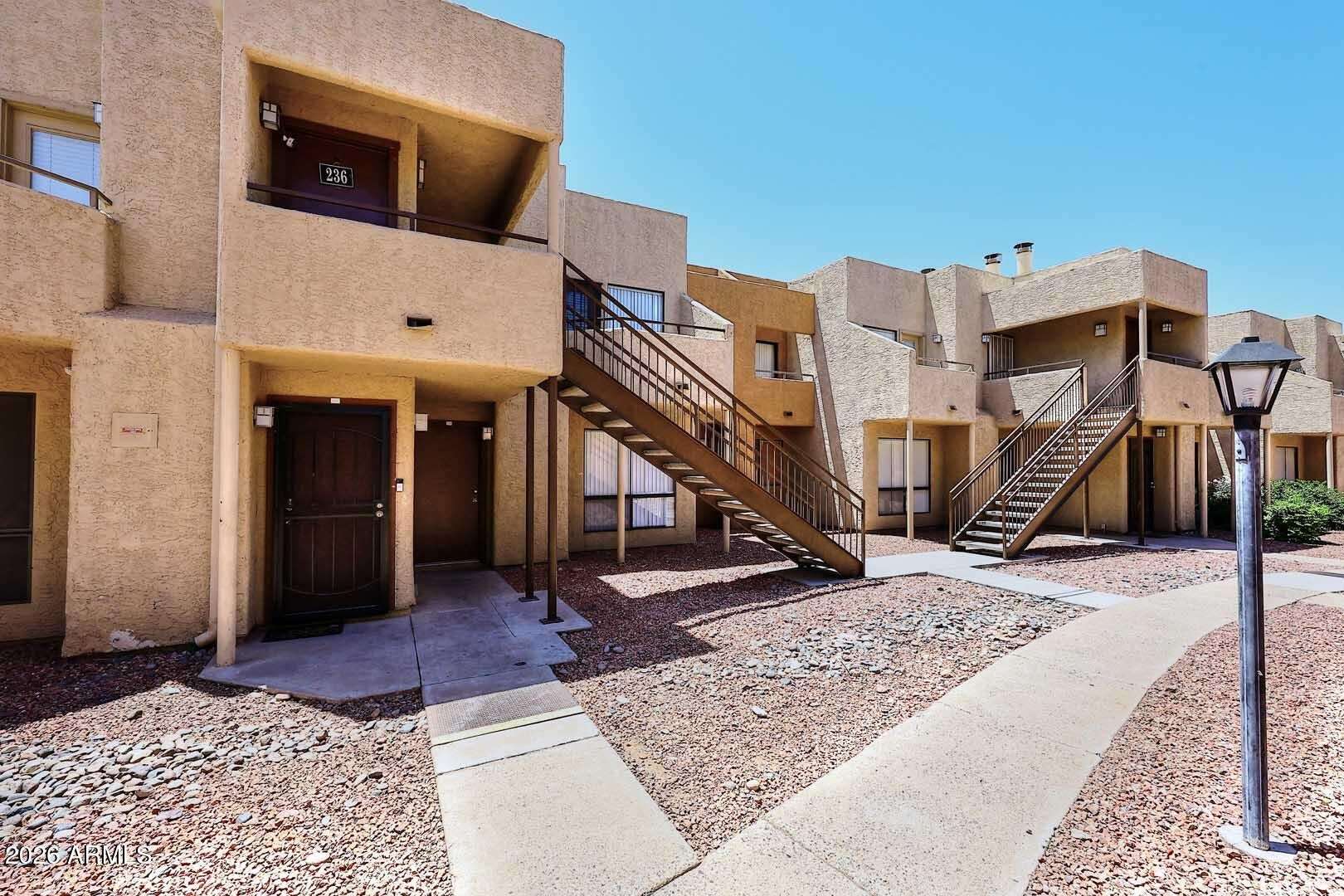 2 of 29. Exterior view highlighting the clean, attractive community design, landscaped walkways, and easy access to the home. Residents enjoy a pool, fitness center, and convenient proximity to everyday amenities.