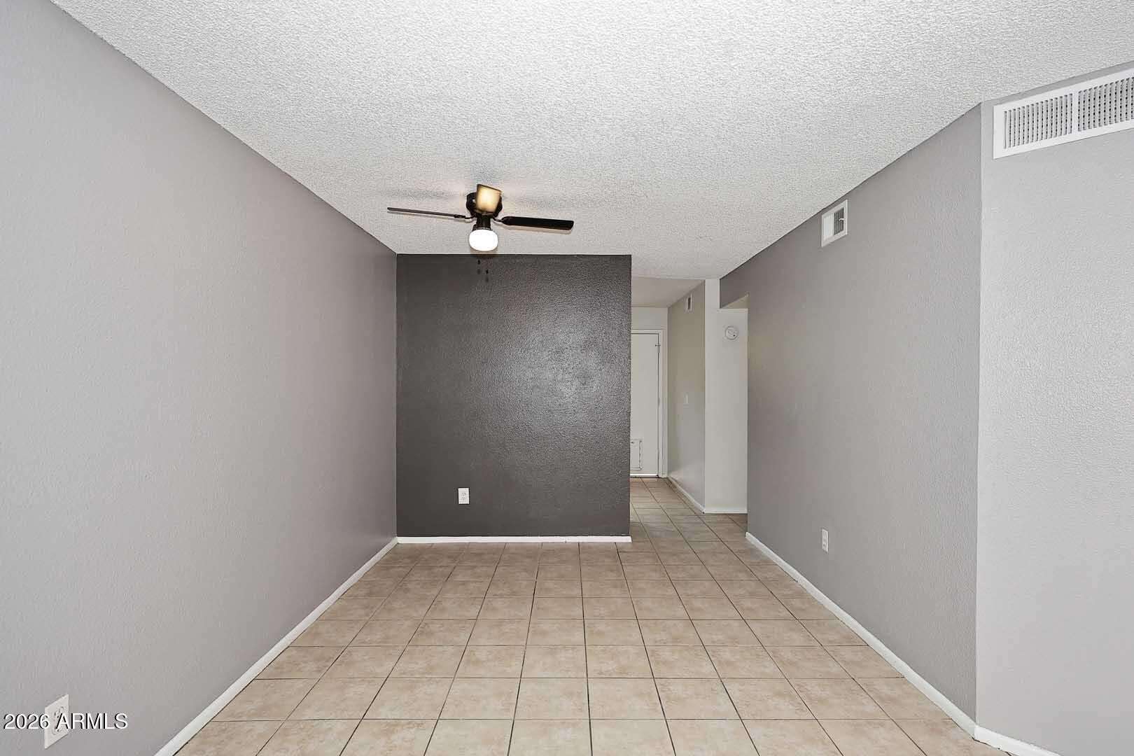 4 of 29. Open dining area with neutral finishes and tile flooring provides the perfect space for casual meals, entertaining, or a home office setup. The layout enhances the home's spacious feel.