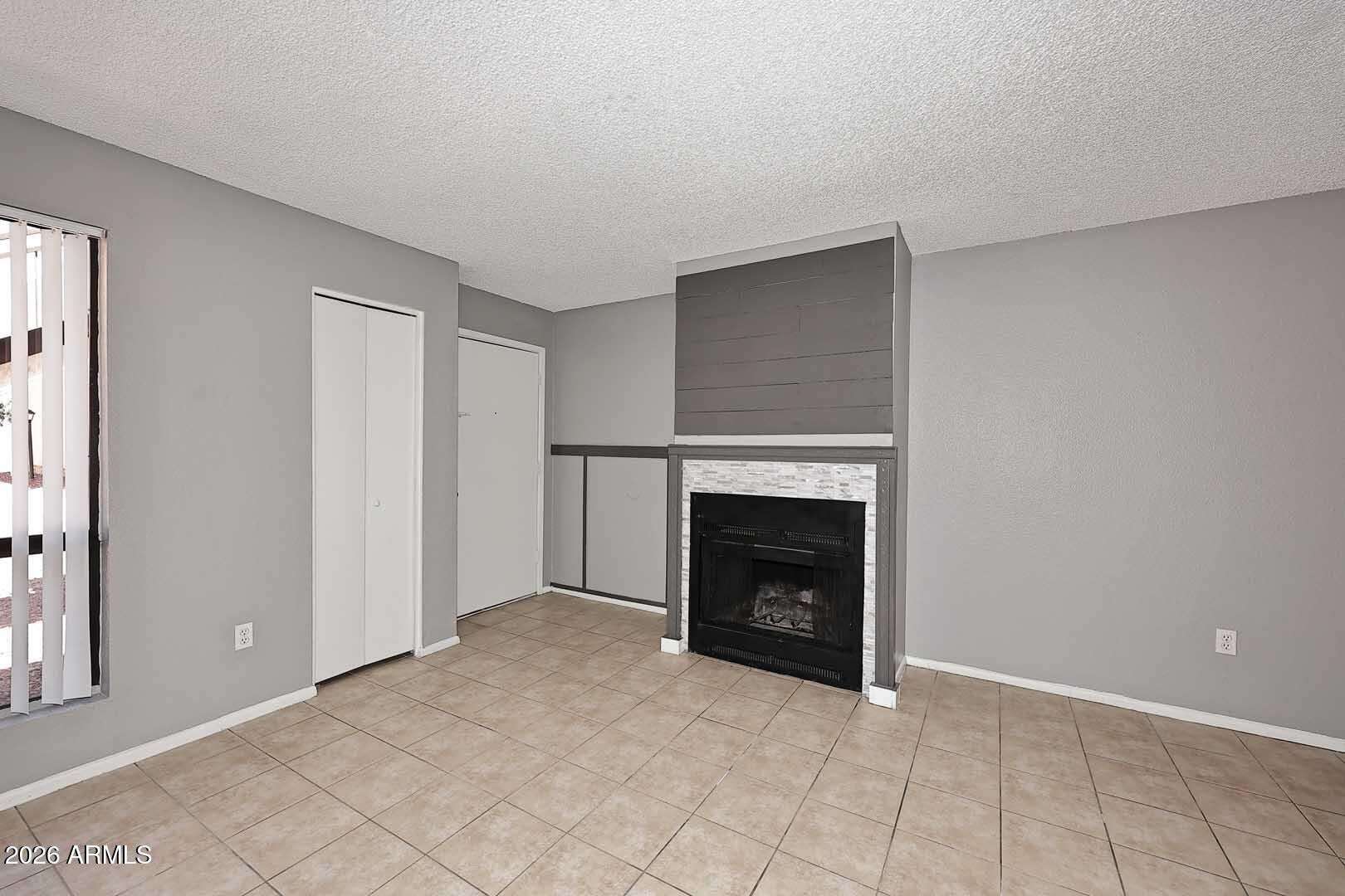 6 of 29. Comfortable living room centered around an updated fireplace feature wall. The open layout and neutral finishes provide a warm and inviting setting for family and guests.