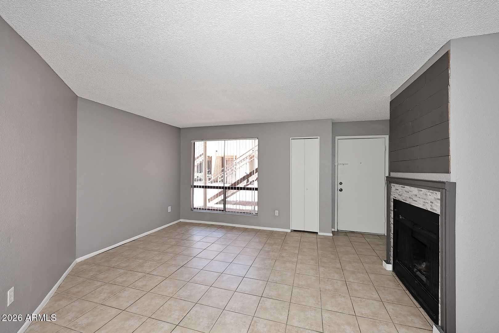 8 of 29. Bright living area featuring abundant natural light, low-maintenance flooring, and a spacious layout. An inviting space designed for comfort and functionality.