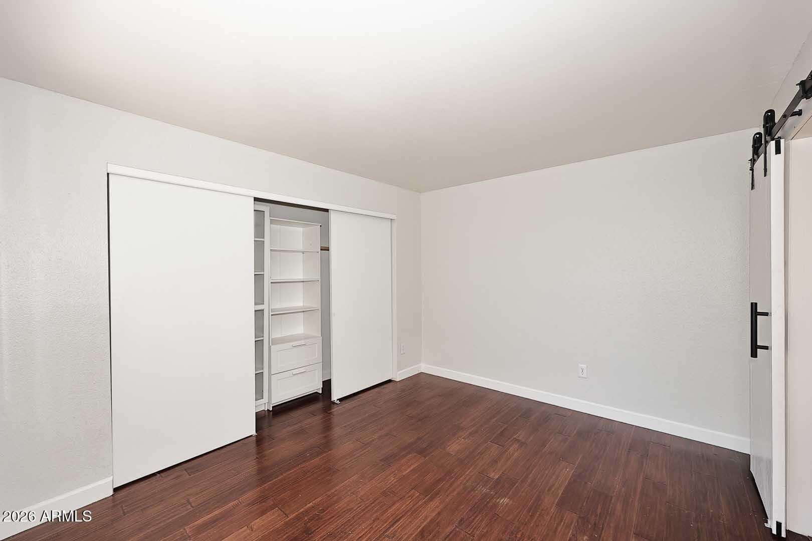 14 of 29. Generous primary bedroom featuring rich flooring, natural light, and a versatile layout. The updated finishes create a comfortable retreat within this Glendale home.