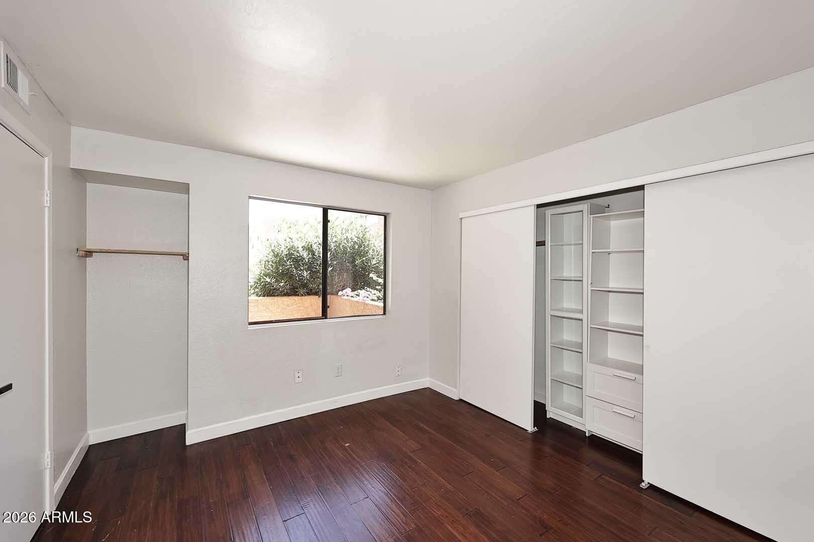 15 of 29. Well-designed primary bedroom featuring custom shelving, integrated storage solutions, and attractive flooring. Functional updates enhance organization and everyday convenience.