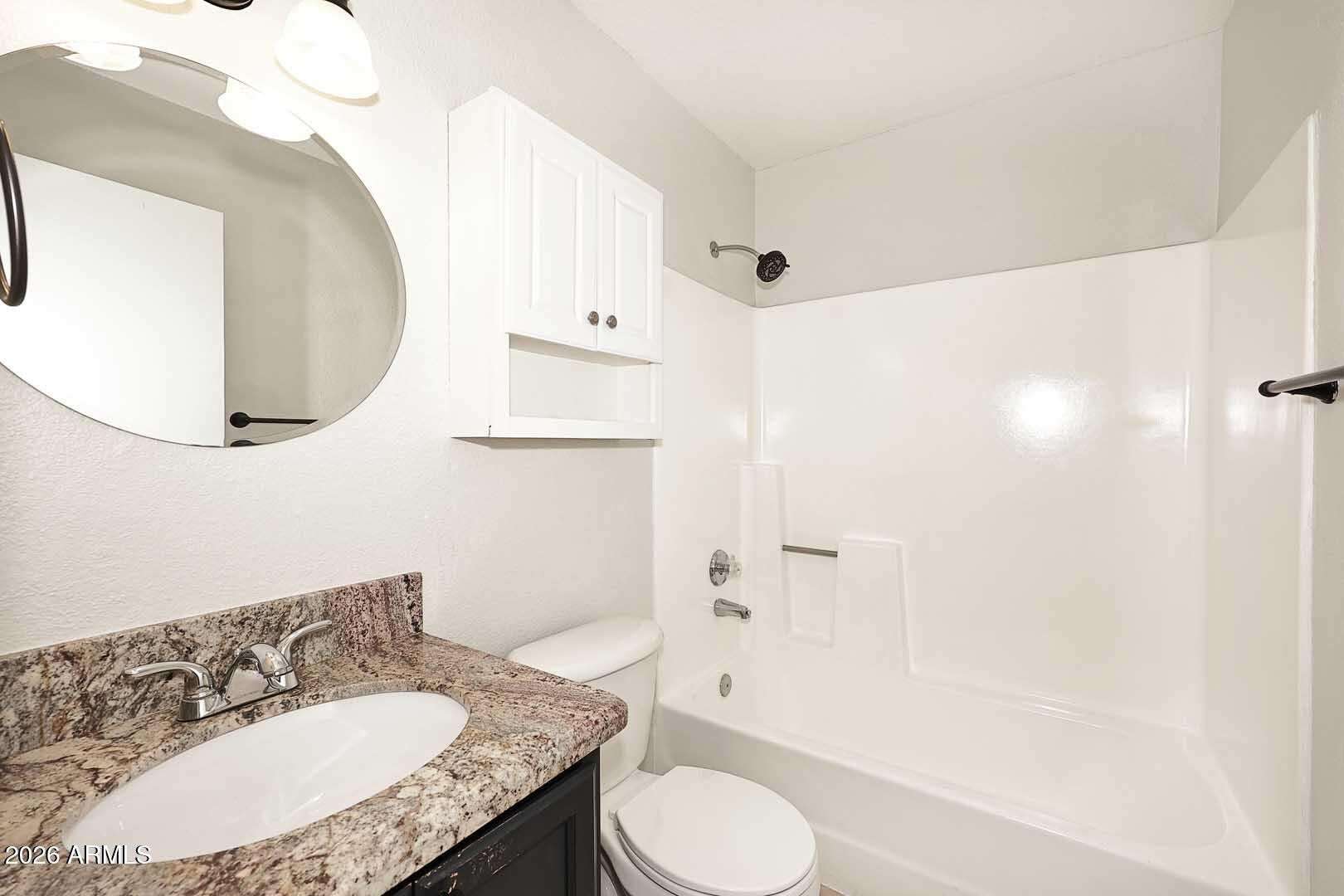21 of 29. Well-maintained guest bathroom featuring a spacious vanity, updated lighting, convenient storage, and a tub-shower combination. Neutral finishes create a clean and inviting space.