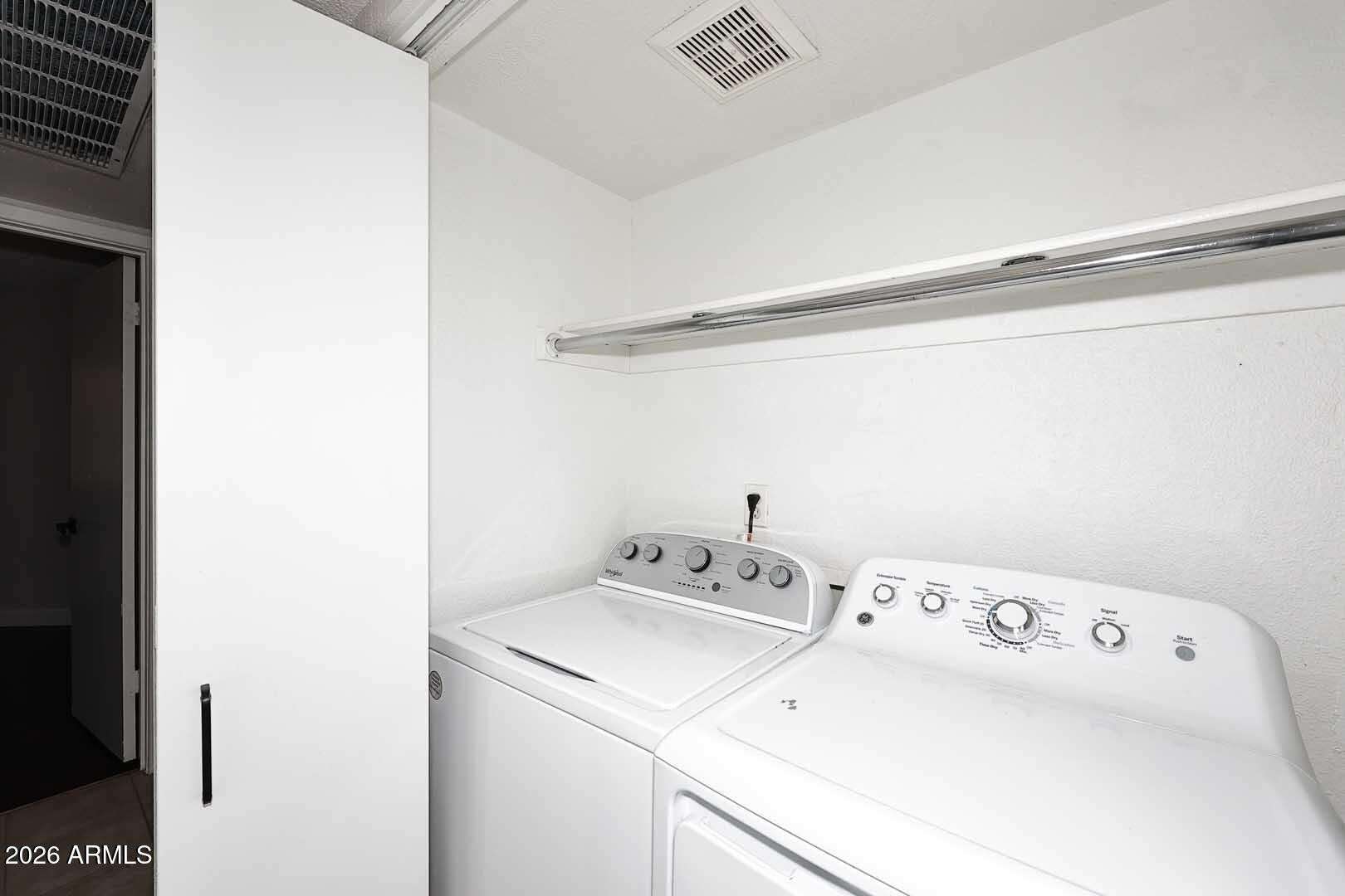 22 of 29. Dedicated laundry room with full-size appliances, overhead shelving, and extra storage capacity. Designed to make daily household tasks simple and efficient.