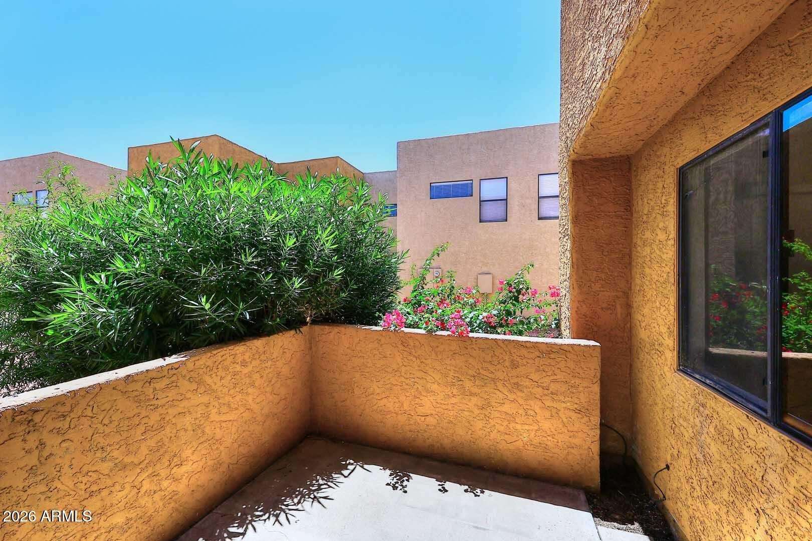 23 of 29. Private patio offering a comfortable outdoor retreat surrounded by mature landscaping. Ideal for relaxing, gardening, or enjoying fresh air just outside your living space.
