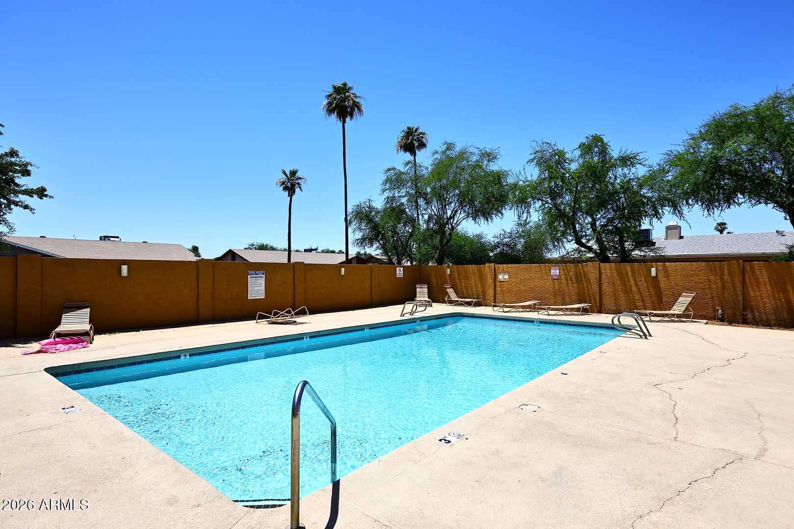 27 of 29. Beautiful community pool surrounded by lounge seating and open sky views. This sought-after amenity provides an excellent place to cool off and unwind.