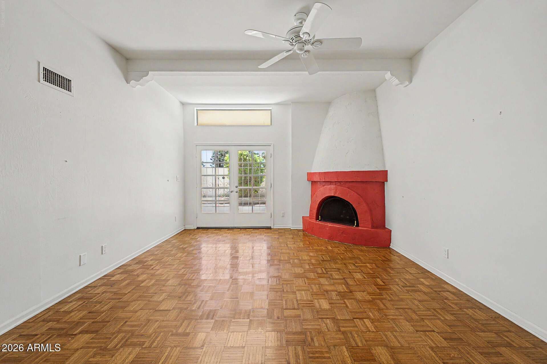 9 of 30. Bright and open living room with vaulted ceilings, architectural details, and warm wood flooring. The flexible layout offers endless possibilities for furnishing and entertaining.