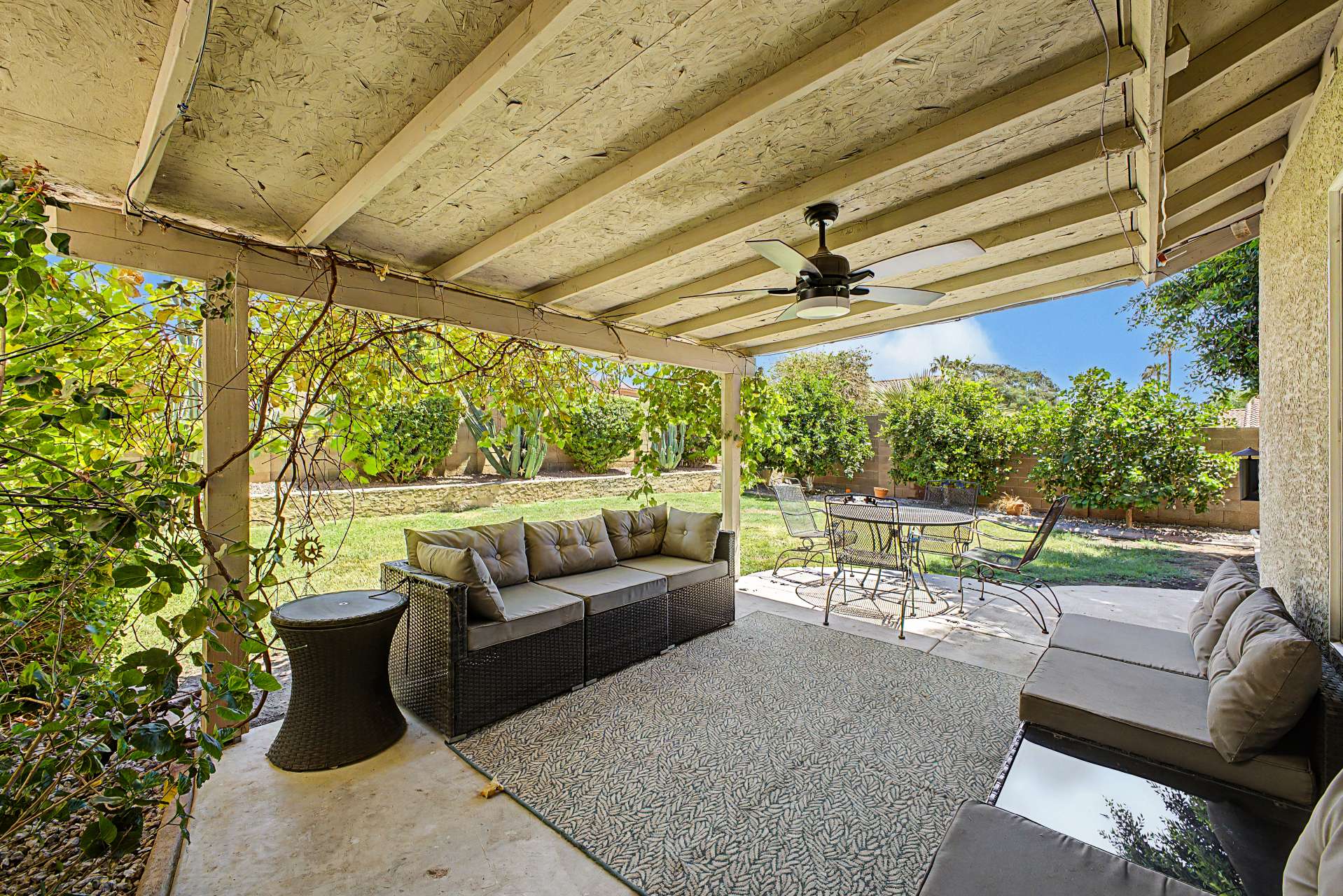 43 of 47. Enjoy outdoor living beneath the covered patio overlooking a spacious backyard with mature landscaping, making it an ideal setting for entertaining, dining, or simply relaxing in Glendale.