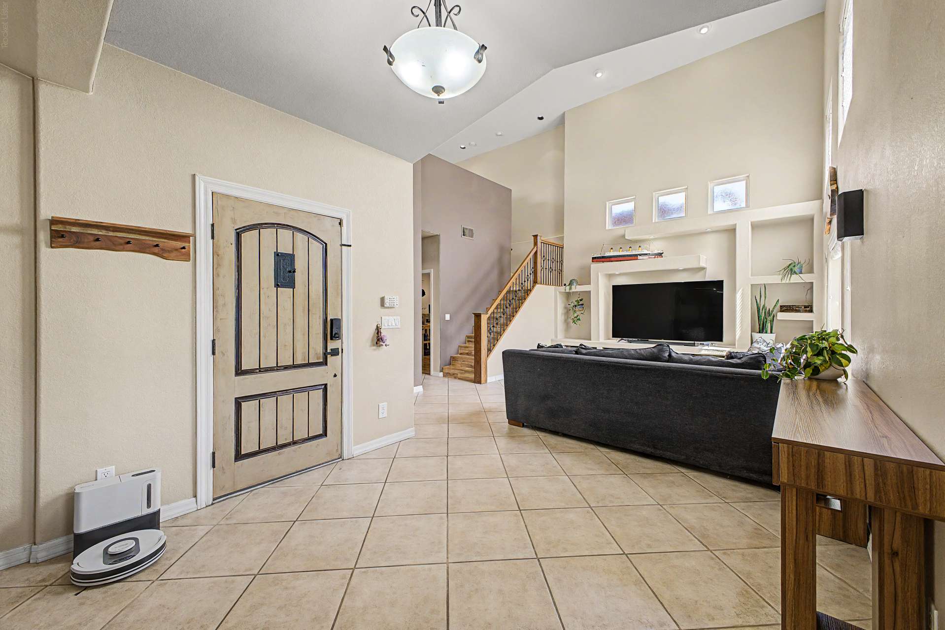 20 of 47. The spacious foyer introduces the home's open-concept design with soaring ceilings, abundant sunlight, neutral finishes, and beautiful tile flooring that seamlessly connects the main living spaces.