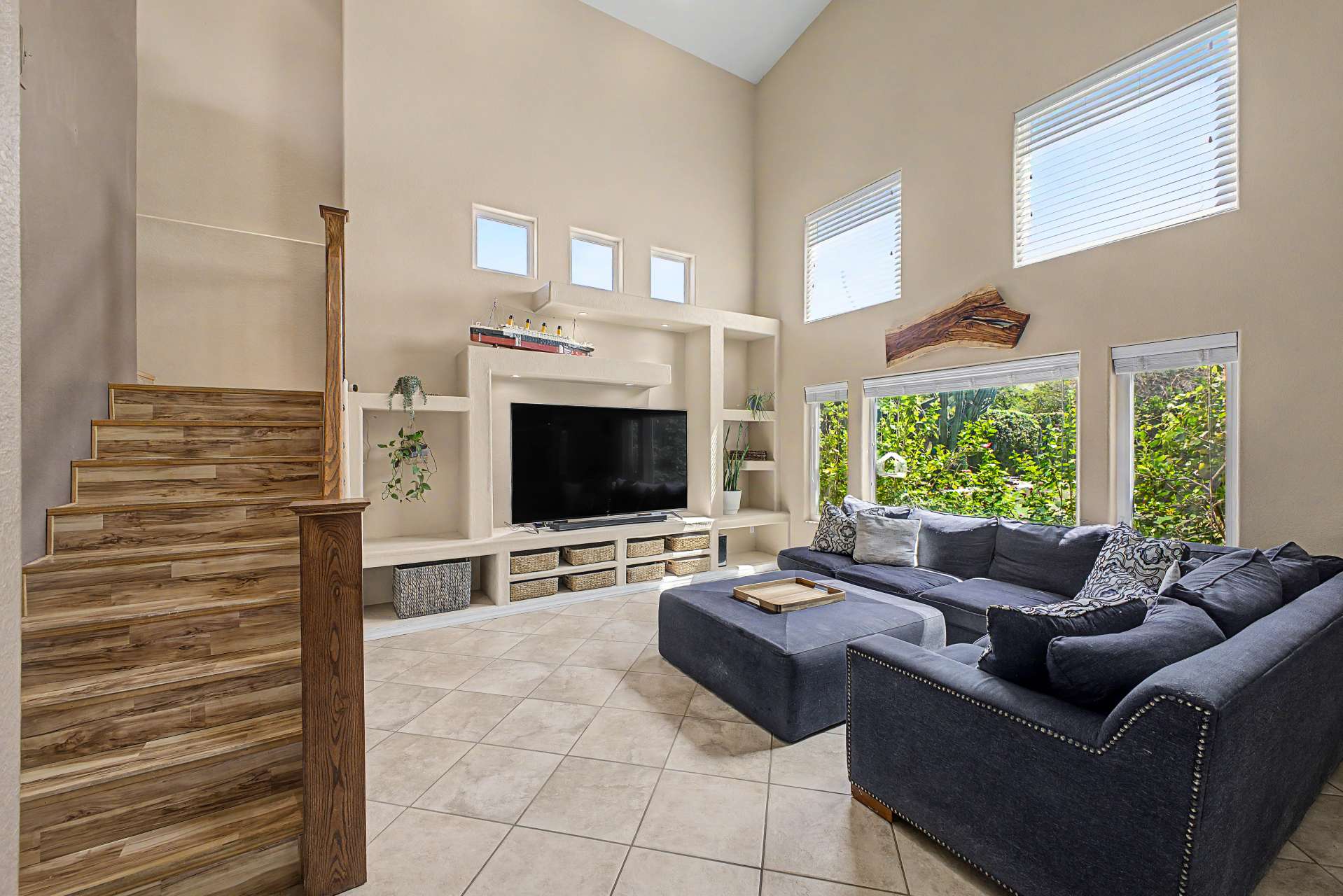 22 of 47. Bright windows, soaring ceilings, and custom built-in shelving create a welcoming living area that offers plenty of room for entertaining, relaxing, and enjoying views of the beautifully landscaped backyard.