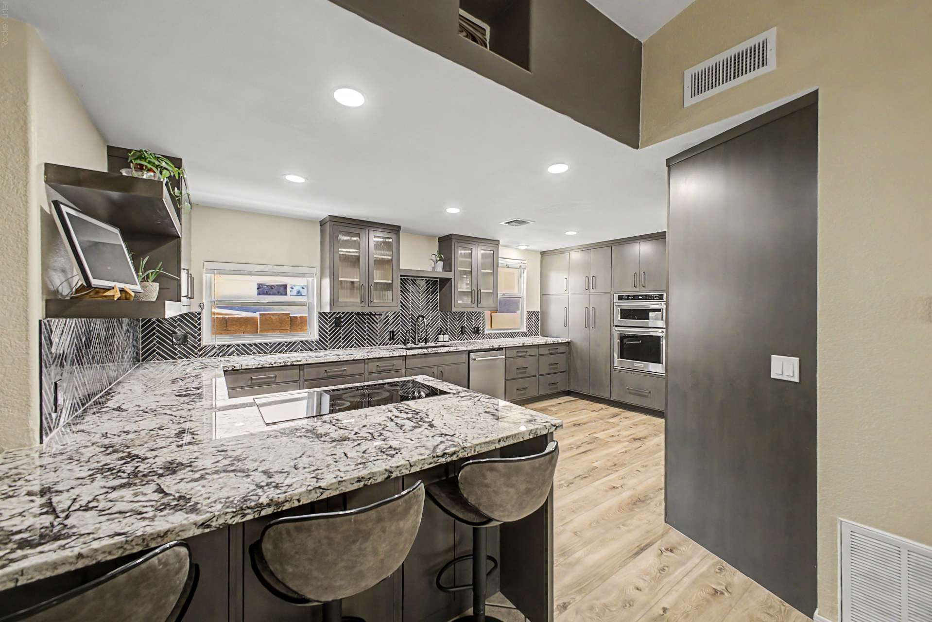 26 of 47. A large granite island anchors this beautifully updated kitchen, offering comfortable seating, premium finishes, abundant prep space, and an open layout ideal for entertaining family and guests.