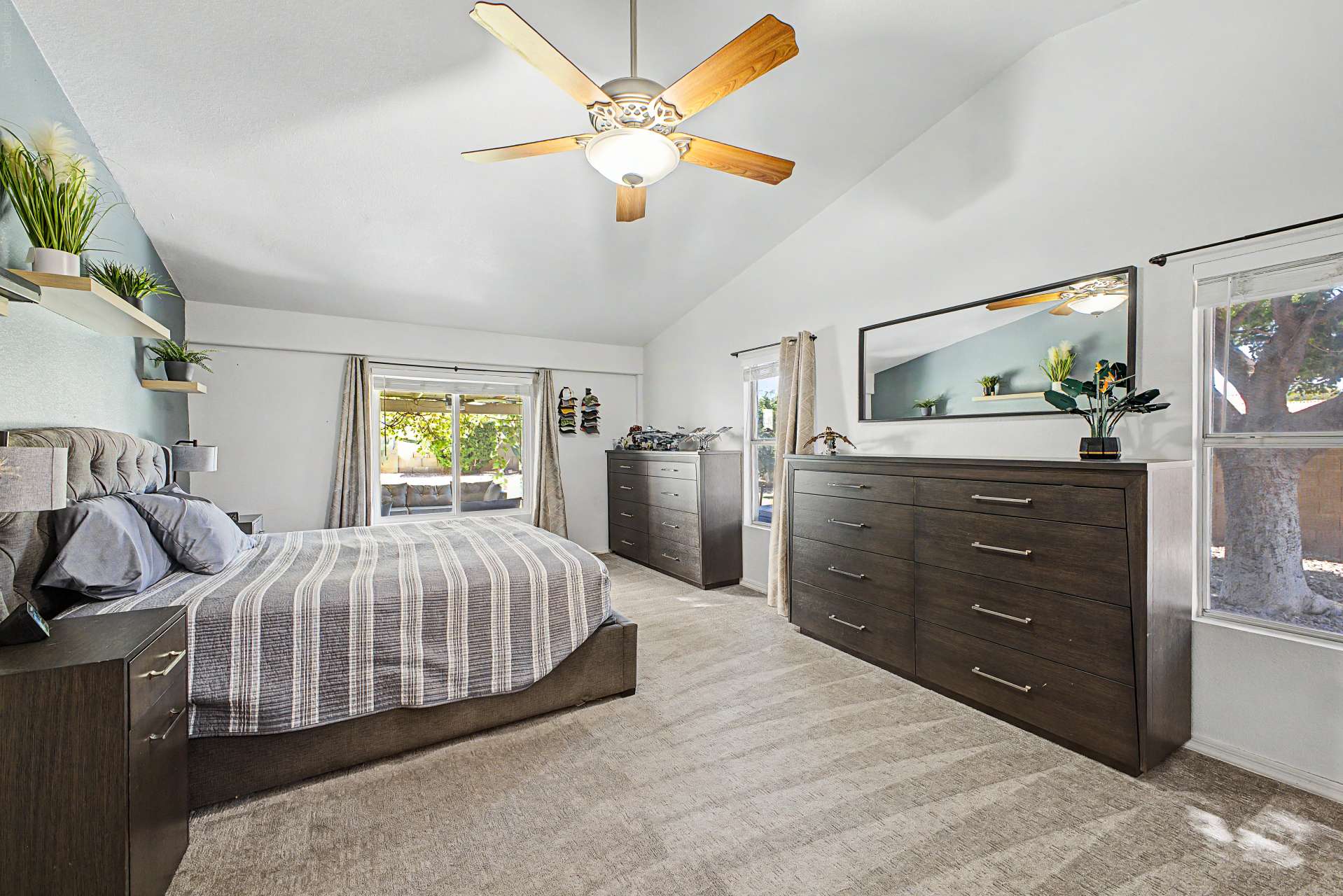 29 of 47. Escape to a spacious primary suite featuring vaulted ceilings, plush carpeting, oversized windows, and plenty of room for a sitting area, offering comfort and privacy at the end of each day.