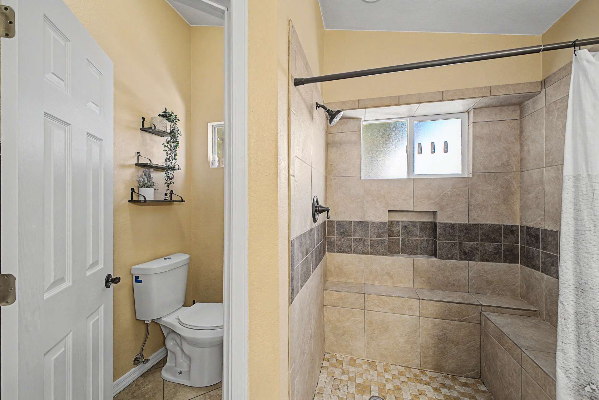 33 of 47. This custom walk-in shower features full-height tile surrounds, built-in bench seating, decorative accent tile, and a spacious design that combines comfort, style, and functionality.