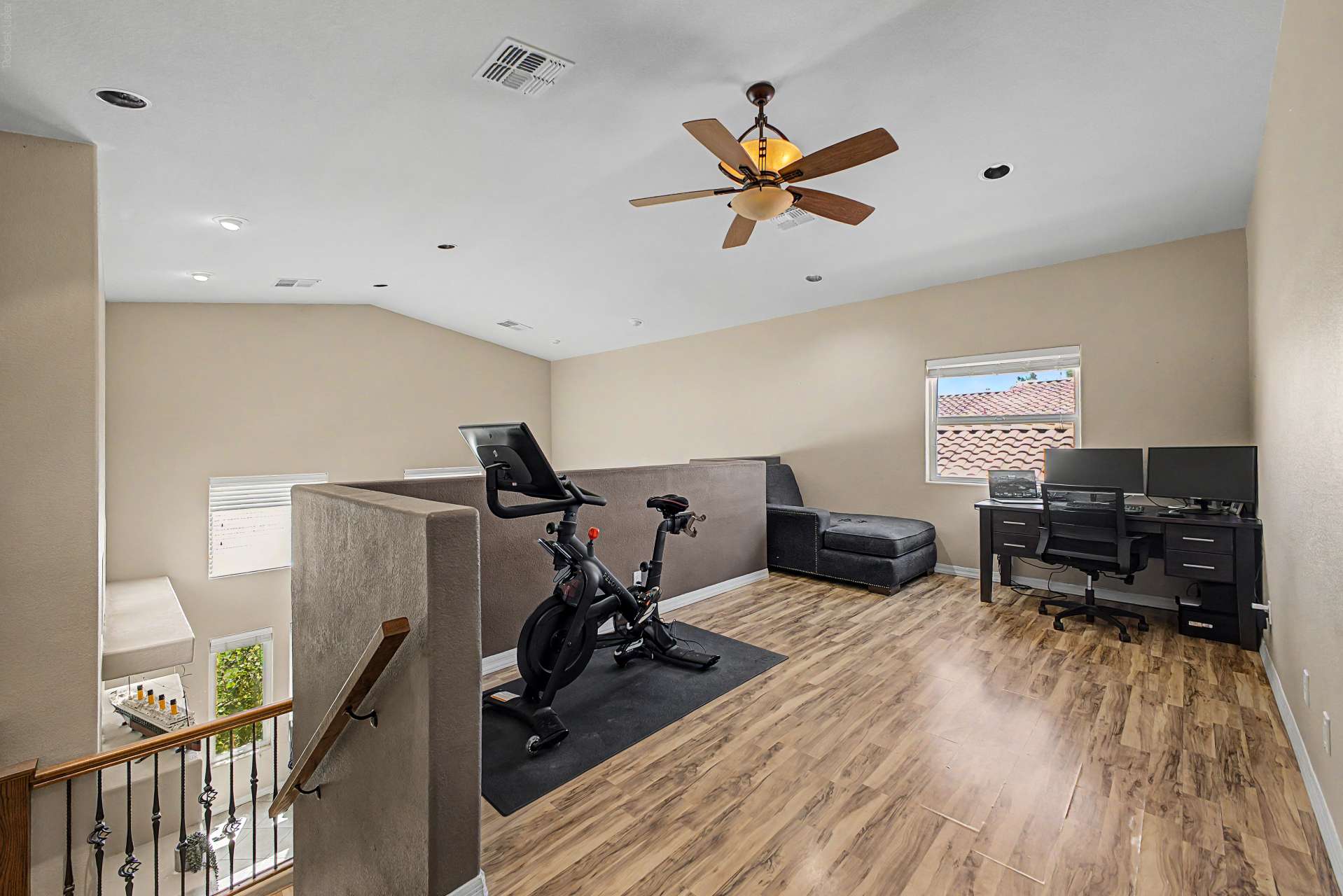 39 of 47. The spacious upstairs loft is ideal for a home office, exercise room, game room, or additional family space, featuring wood-look flooring, recessed lighting, and an open layout.