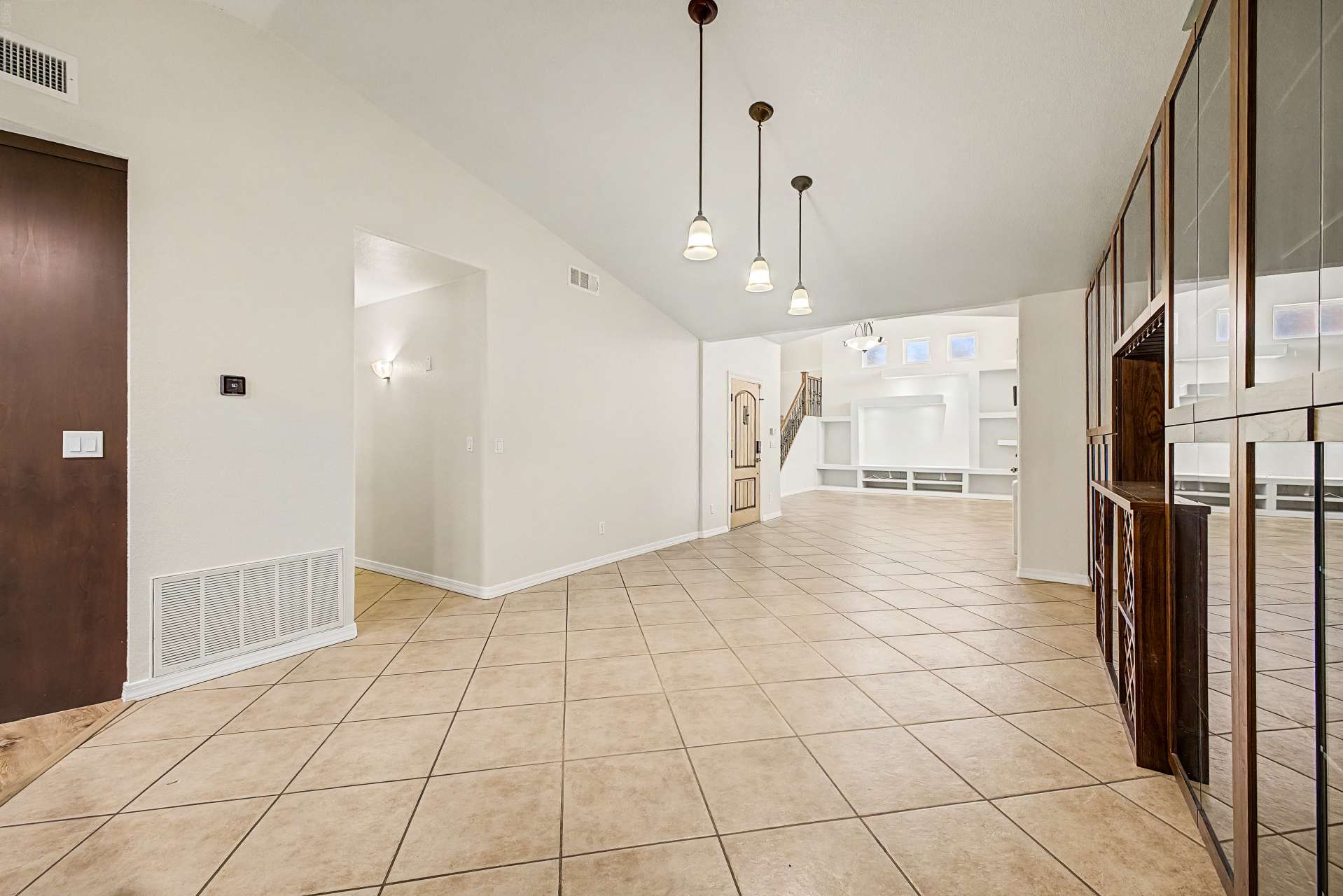 5 of 47. Spacious living areas with tile flooring and an open floor plan provide endless possibilities for relaxing, hosting guests, or creating personalized gathering spaces throughout this Glendale property.