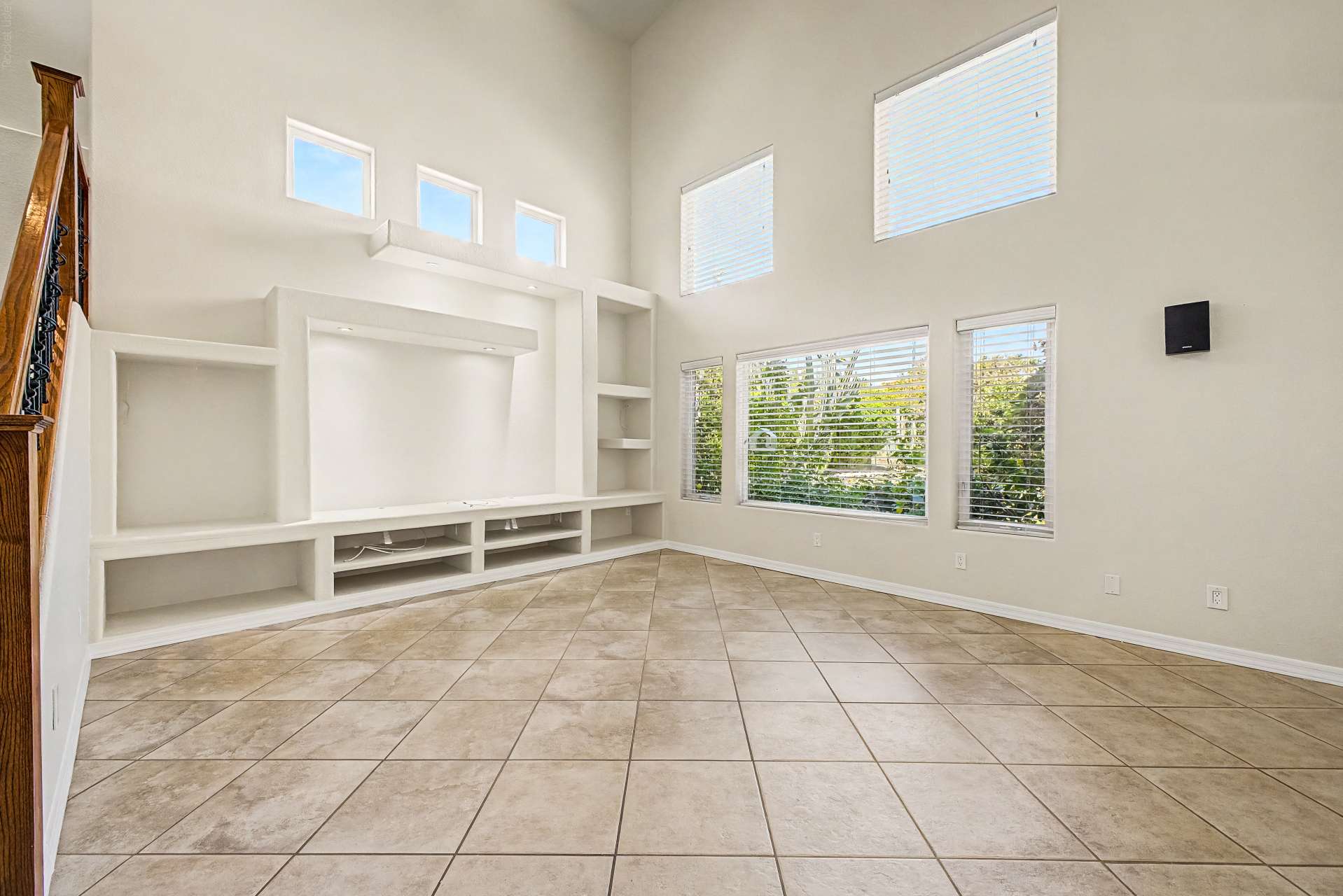 7 of 47. Bright windows, expansive ceilings, and custom built-in shelving combine to create a welcoming living space ideal for entertaining, relaxing, or spending time with family.