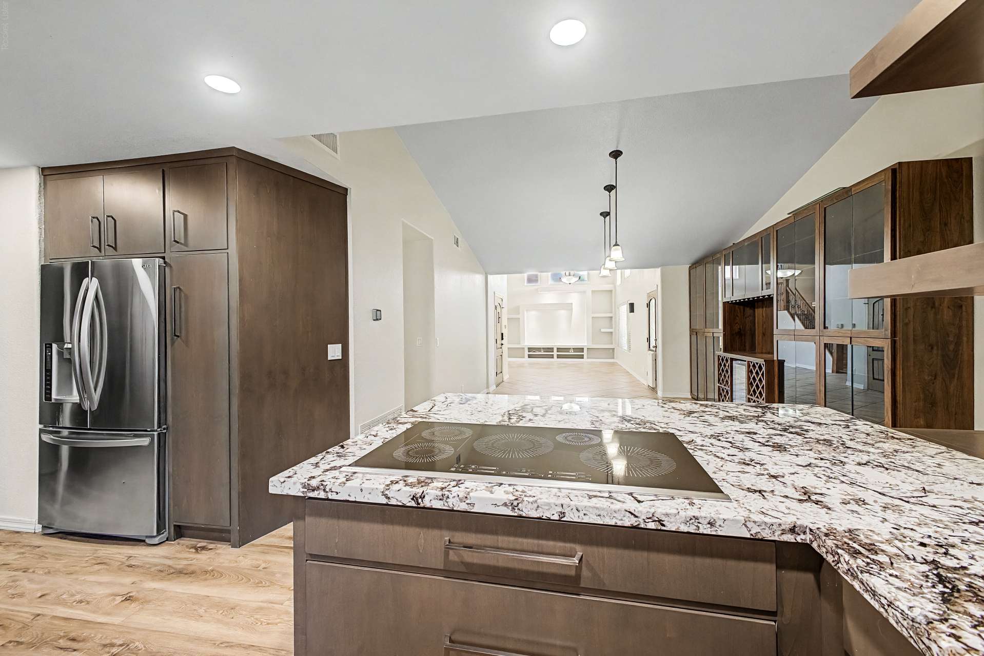 9 of 47. Premium granite countertops, an oversized island, induction cooktop, custom cabinetry, and stainless steel appliances create a stylish and highly functional kitchen for today's lifestyle.