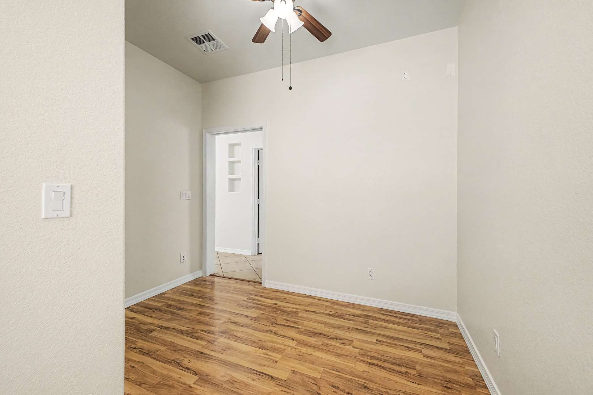 15 of 47. This spacious bedroom combines updated flooring, vaulted ceilings, and a ceiling fan to create a welcoming retreat with flexible use for guests, family members, or a home office in this Glendale home.
