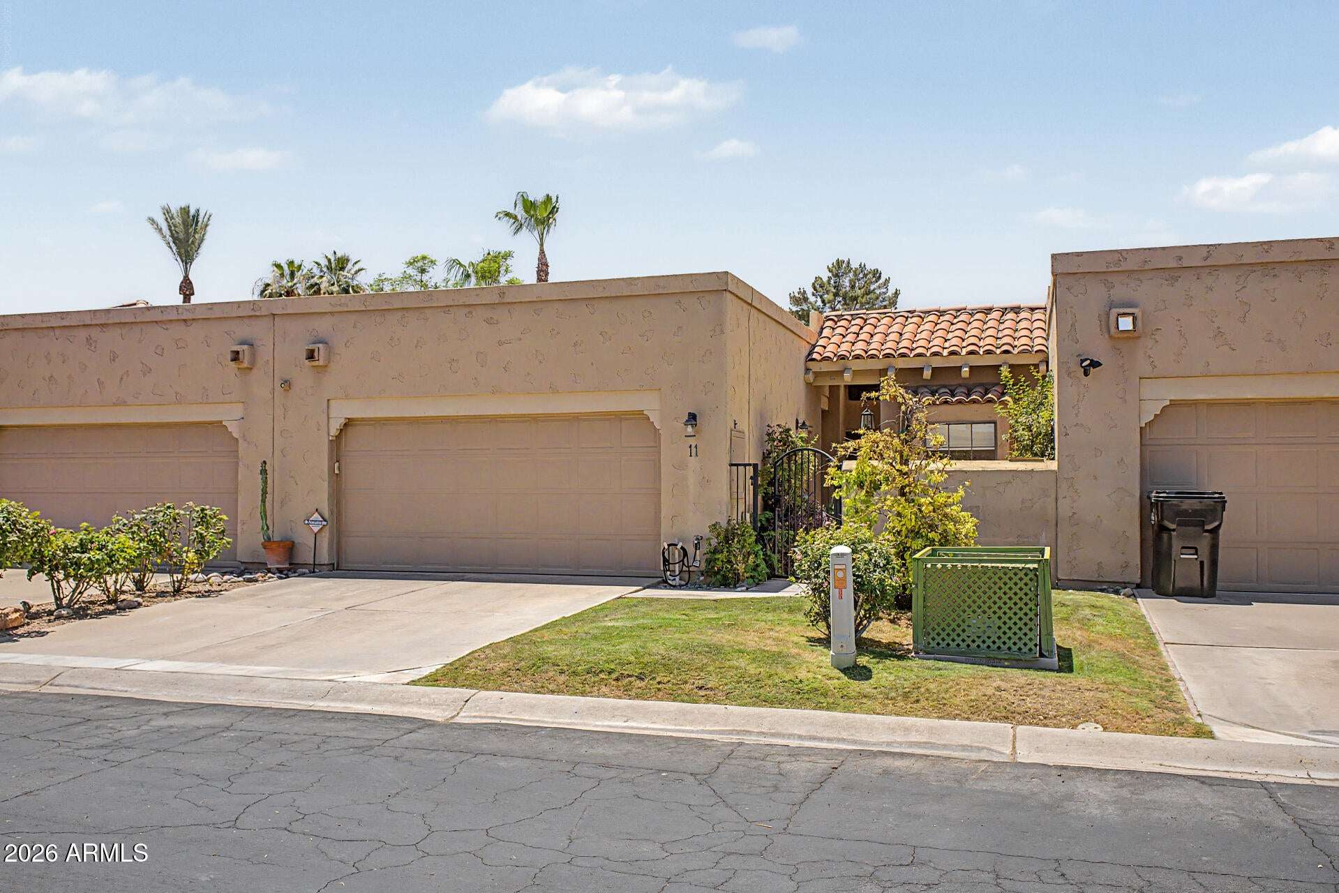 2 of 30. Beautiful front fa ade with a private courtyard entrance, garage parking, and mature greenery. The thoughtfully designed exterior reflects the easy-care lifestyle buyers seek in Scottsdale real estate.