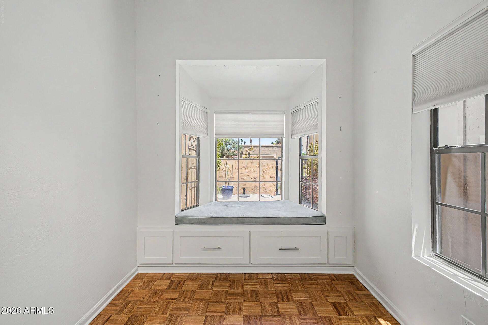 7 of 30. Cozy built-in window seat framed by large windows that bring in natural light and courtyard views. This versatile area can serve as a breakfast nook, reading corner, or relaxing retreat.