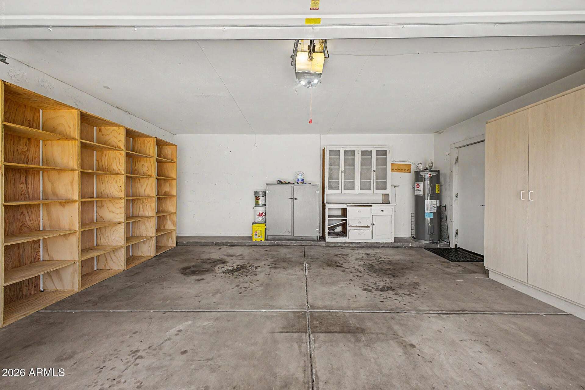 23 of 30. Large two-car garage offering extensive shelving, storage cabinetry, and room for projects or recreational equipment. A highly functional space with exceptional storage potential.