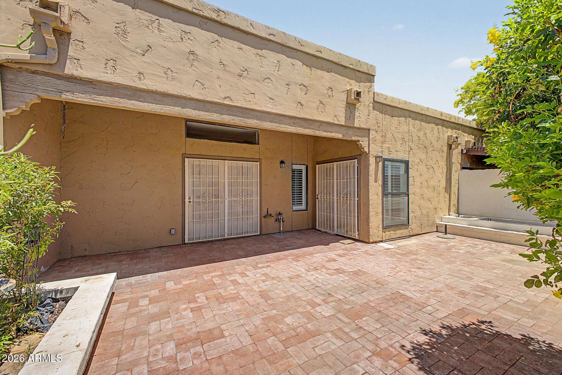 25 of 30. Private courtyard with durable paver flooring, mature landscaping, and ample room for outdoor furnishings. The low-maintenance design encourages year-round outdoor enjoyment.