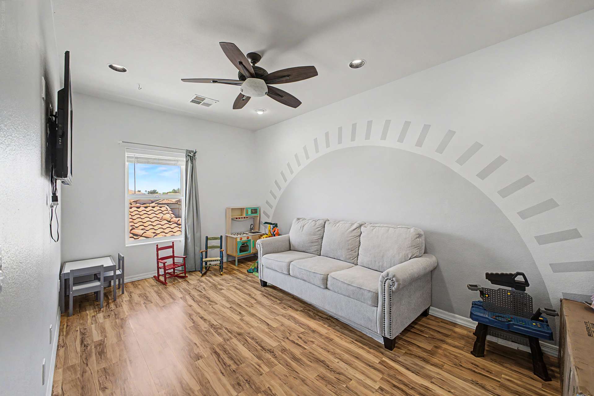 40 of 47. This generous upstairs living area offers endless possibilities as a media room, children's playroom, home office, or lounge, complete with updated flooring and ceiling fan.