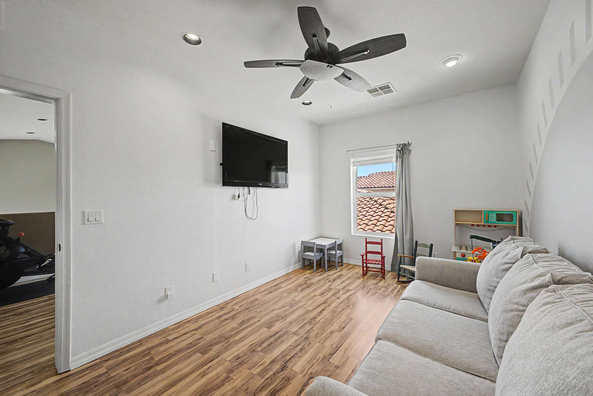41 of 47. A bright and spacious flex room with wood-look flooring and modern finishes provides the perfect space for relaxing, entertaining, working from home, or family activities.