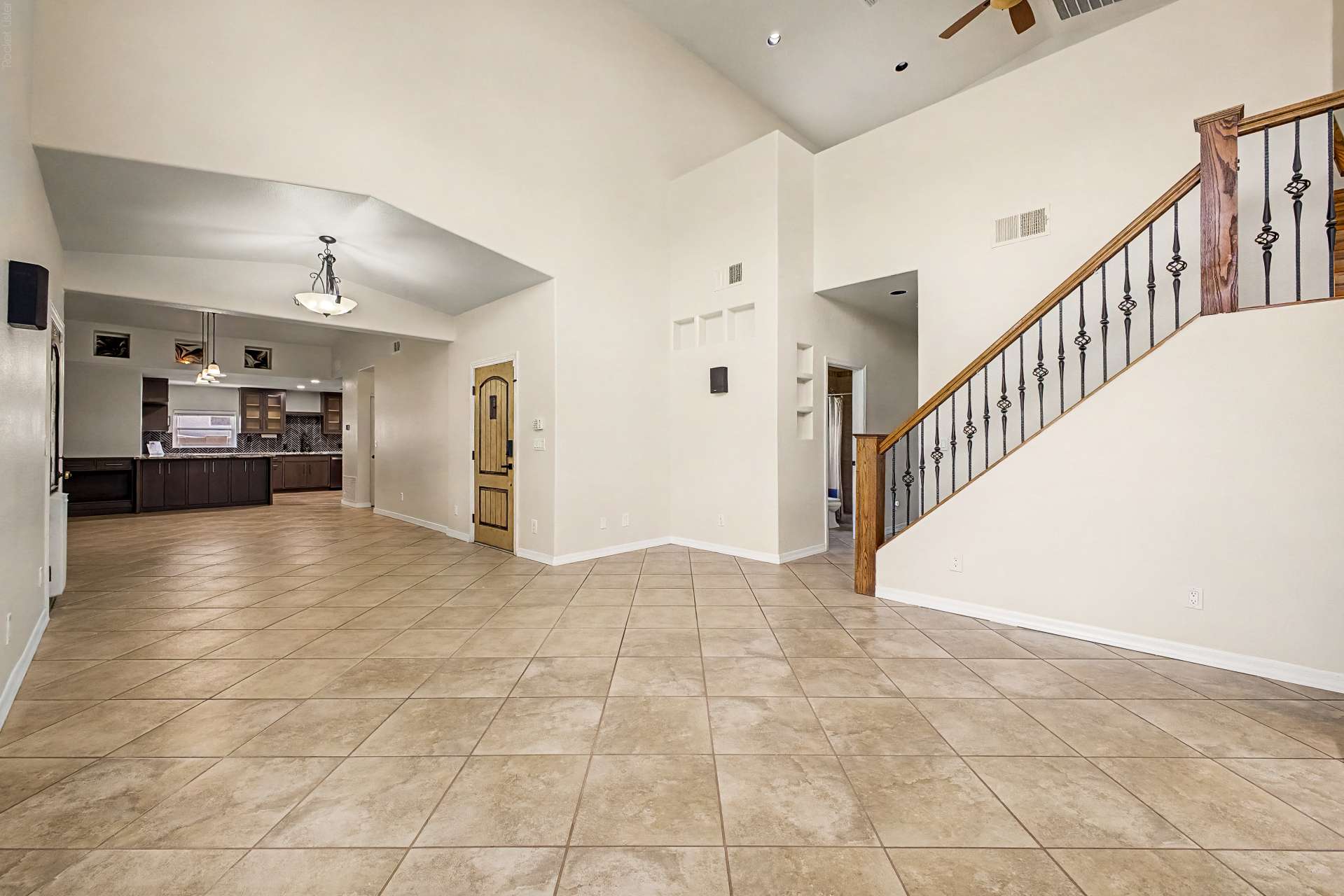 8 of 47. An airy floor plan with dramatic ceilings, elegant staircase, and seamless flow into the remodeled kitchen makes this Glendale home ideal for entertaining and comfortable daily living.