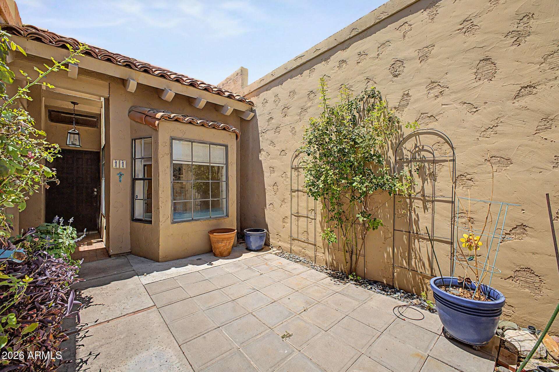 3 of 30. Private courtyard retreat featuring ample patio space for outdoor seating, gardening, and entertaining. This secluded outdoor area enhances the home's indoor-outdoor lifestyle appeal.