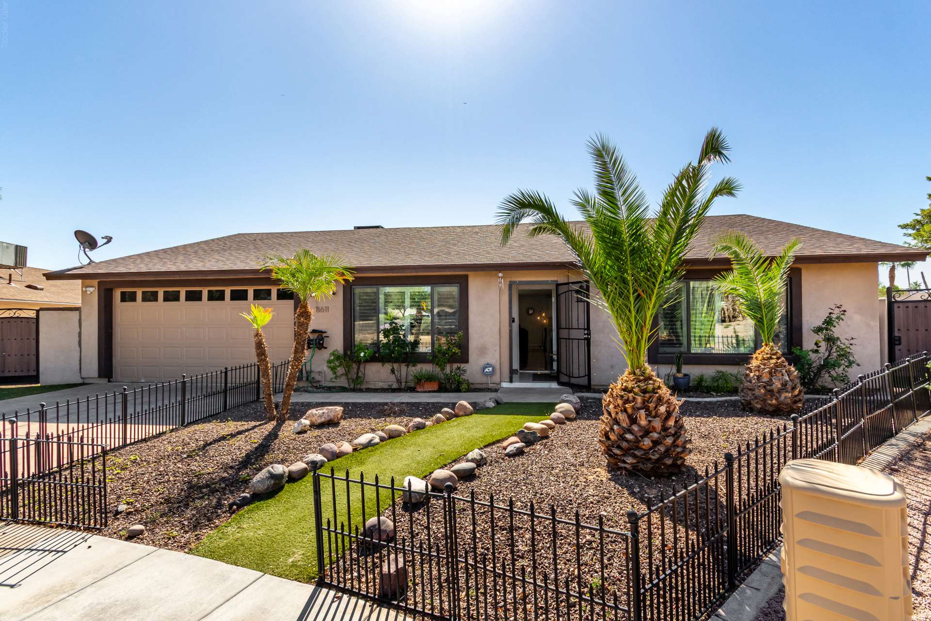 1 of 34. Beautiful desert landscaping, palm trees, decorative rock accents, and an inviting walkway create exceptional curb appeal. This Scottsdale home's attractive exterior offers low-maintenance beauty.