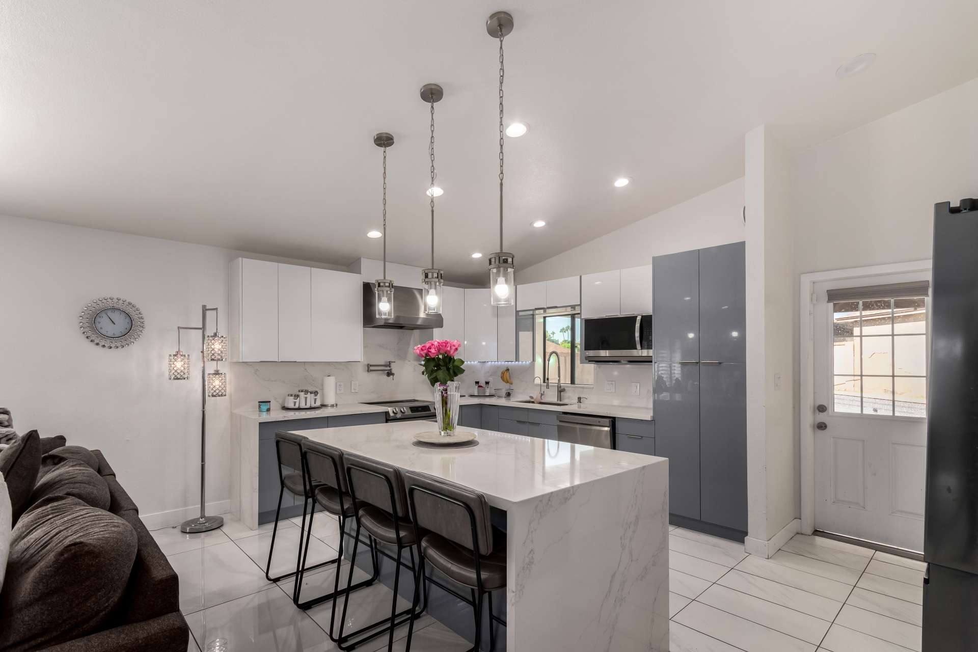 6 of 34. This modern kitchen blends sleek finishes with practical design, offering quartz countertops, stainless steel appliances, abundant cabinetry, and an open layout that complements today's lifestyle.