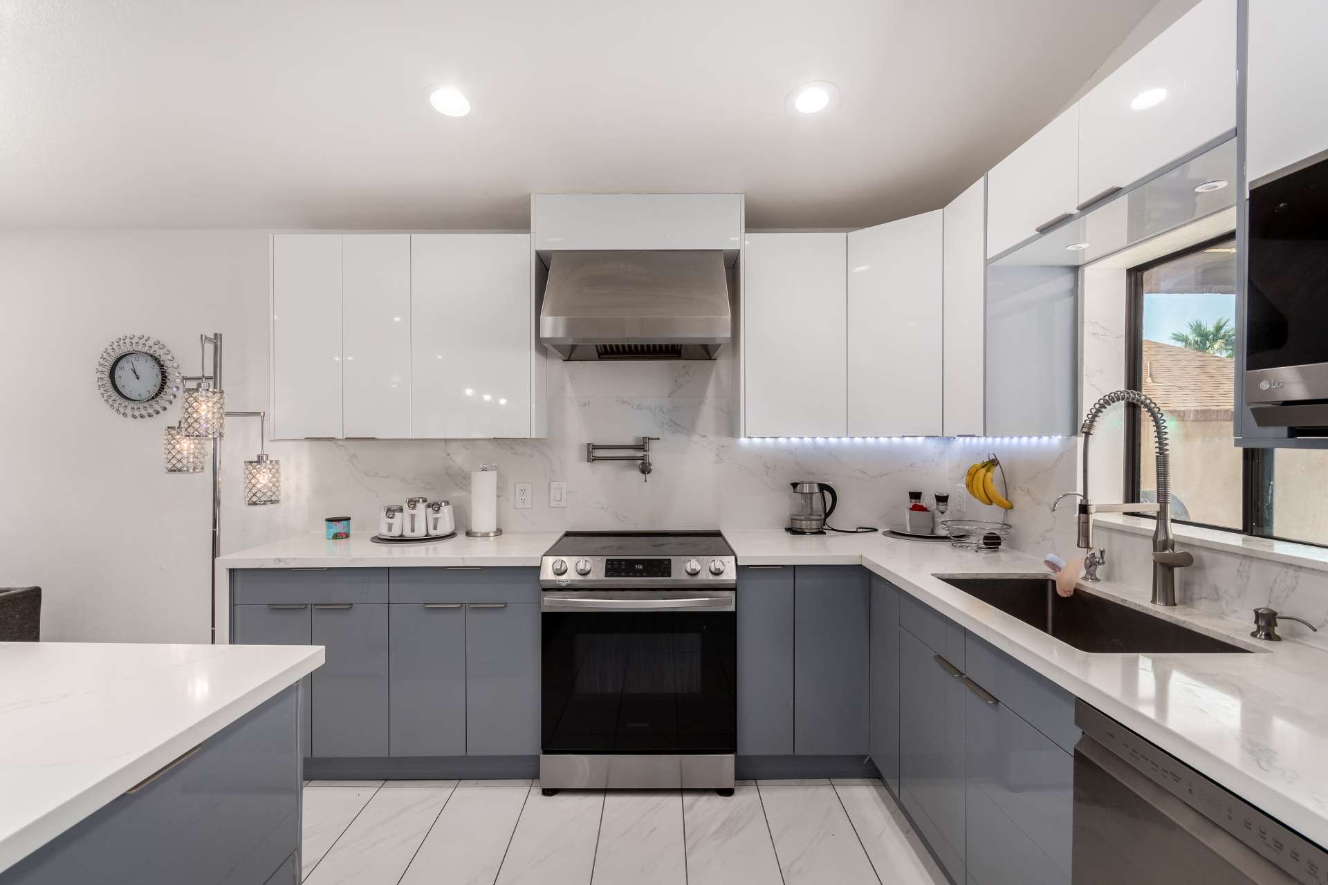 8 of 34. Clean lines, quartz surfaces, stainless steel appliances, and abundant cabinetry make this renovated kitchen both beautiful and highly functional. An ideal centerpiece for this Scottsdale home.