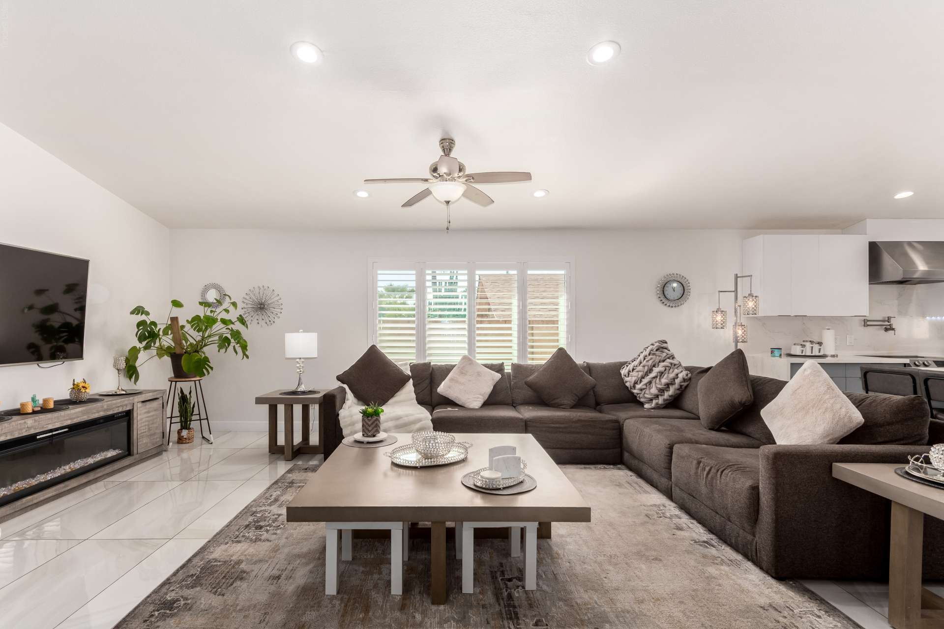 12 of 34. The bright great room offers generous seating space, contemporary finishes, and seamless access to the kitchen. Large windows fill the Scottsdale home with natural light for comfortable everyday living.