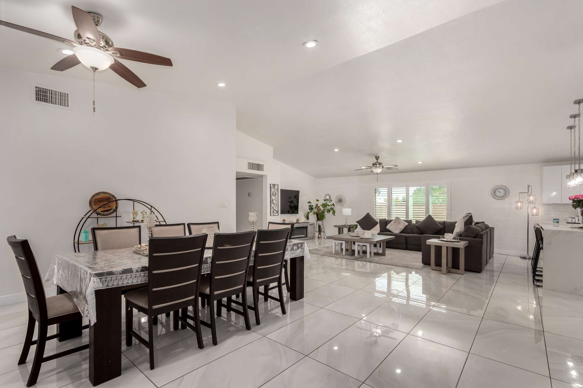 14 of 34. This expansive dining area blends effortlessly with the great room, creating flexible living space for entertaining or everyday meals. Bright interiors and vaulted ceilings enhance the Scottsdale home's appeal.