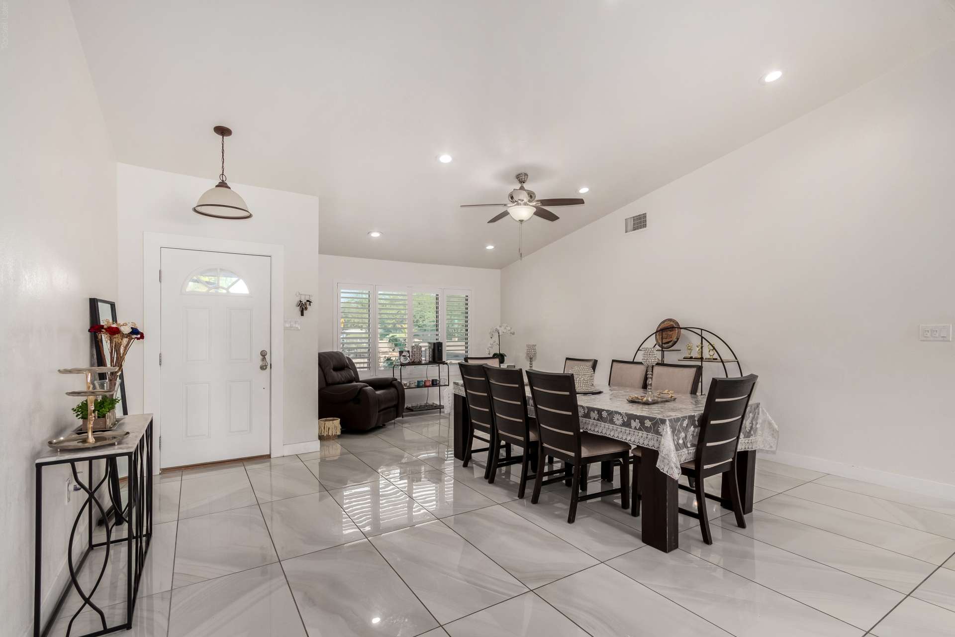 15 of 34. Host memorable dinners in this spacious dining room featuring beautiful tile flooring, soaring ceilings, and an open layout that connects naturally with the main living spaces of this Scottsdale home.