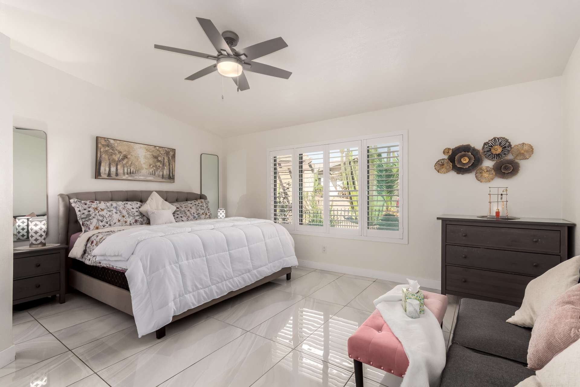 17 of 34. The spacious primary bedroom provides a relaxing escape with plantation shutters, elegant finishes, abundant natural light, and room for a sitting area. Comfort and functionality come together beautifully.