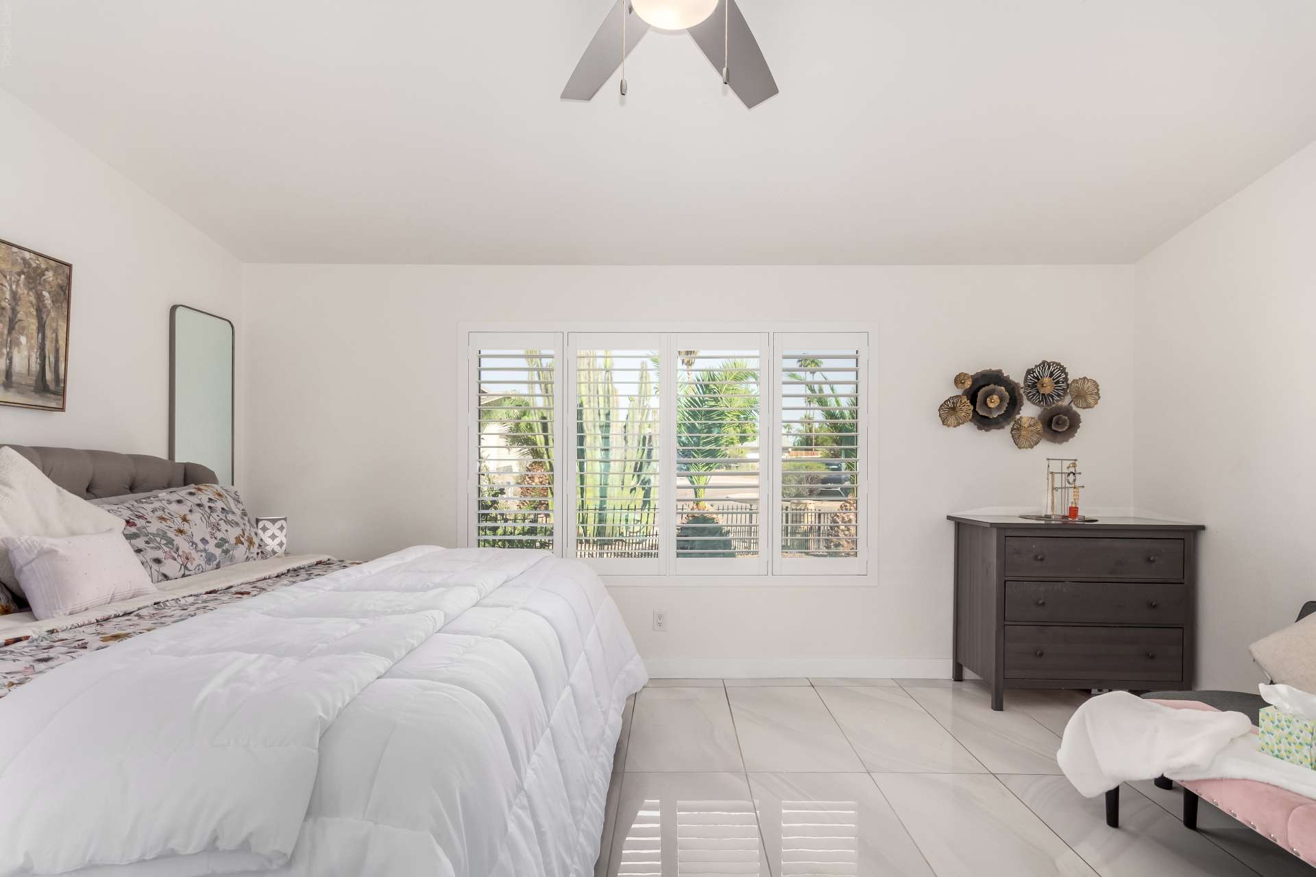 20 of 34. Enjoy peaceful mornings in this bright primary suite featuring plantation shutters, spacious proportions, and elegant finishes. This comfortable Scottsdale bedroom offers both privacy and everyday convenience.