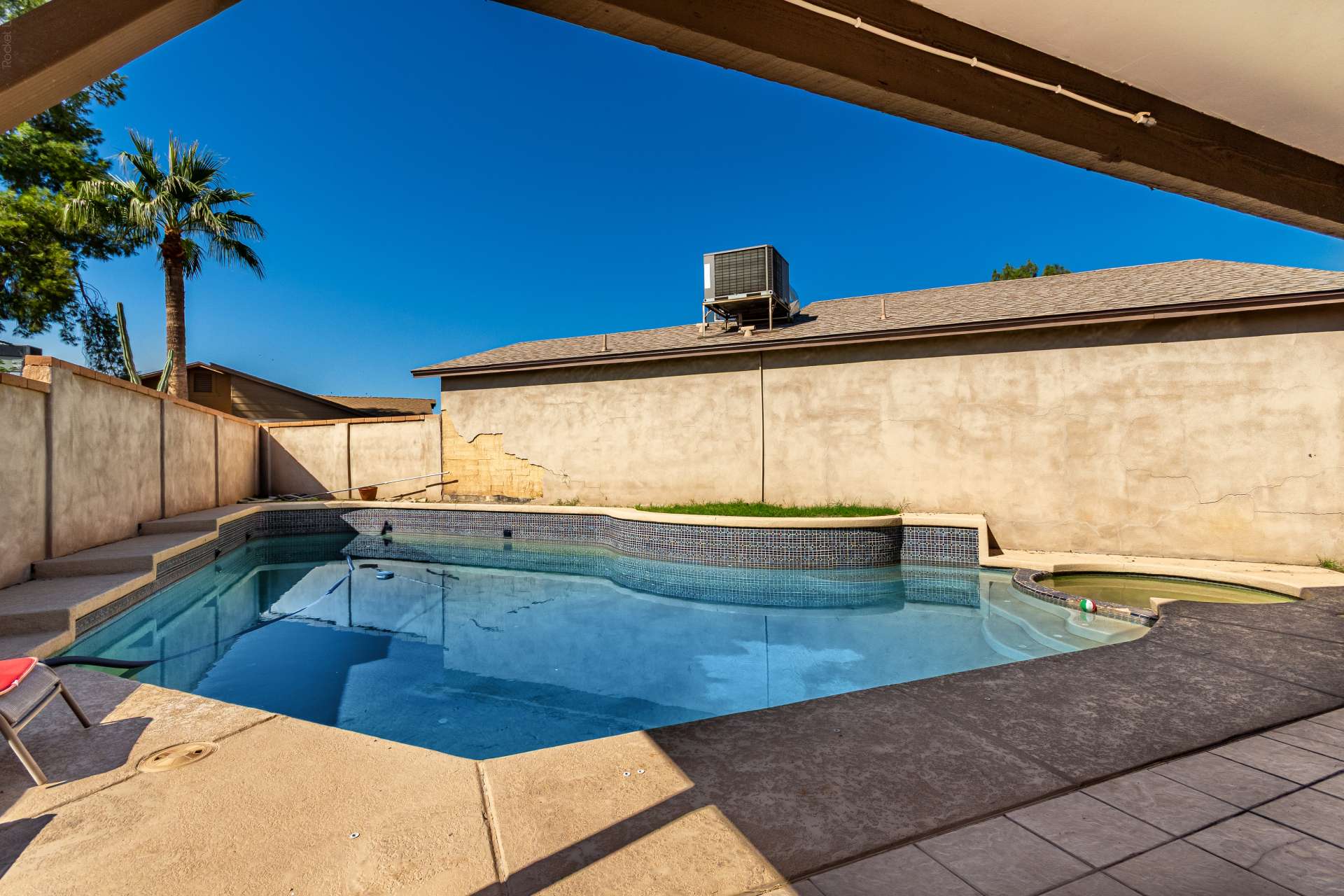 30 of 34. Private backyard retreat featuring a sparkling swimming pool, relaxing spa, covered patio, and easy-care outdoor living space perfect for enjoying Scottsdale's beautiful weather.