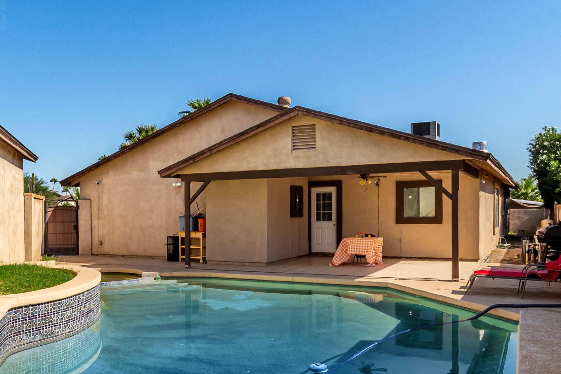 2 of 34. Relax and entertain beside the sparkling swimming pool with a covered patio and generous outdoor living space. This Scottsdale backyard is designed for year-round enjoyment and memorable gatherings.