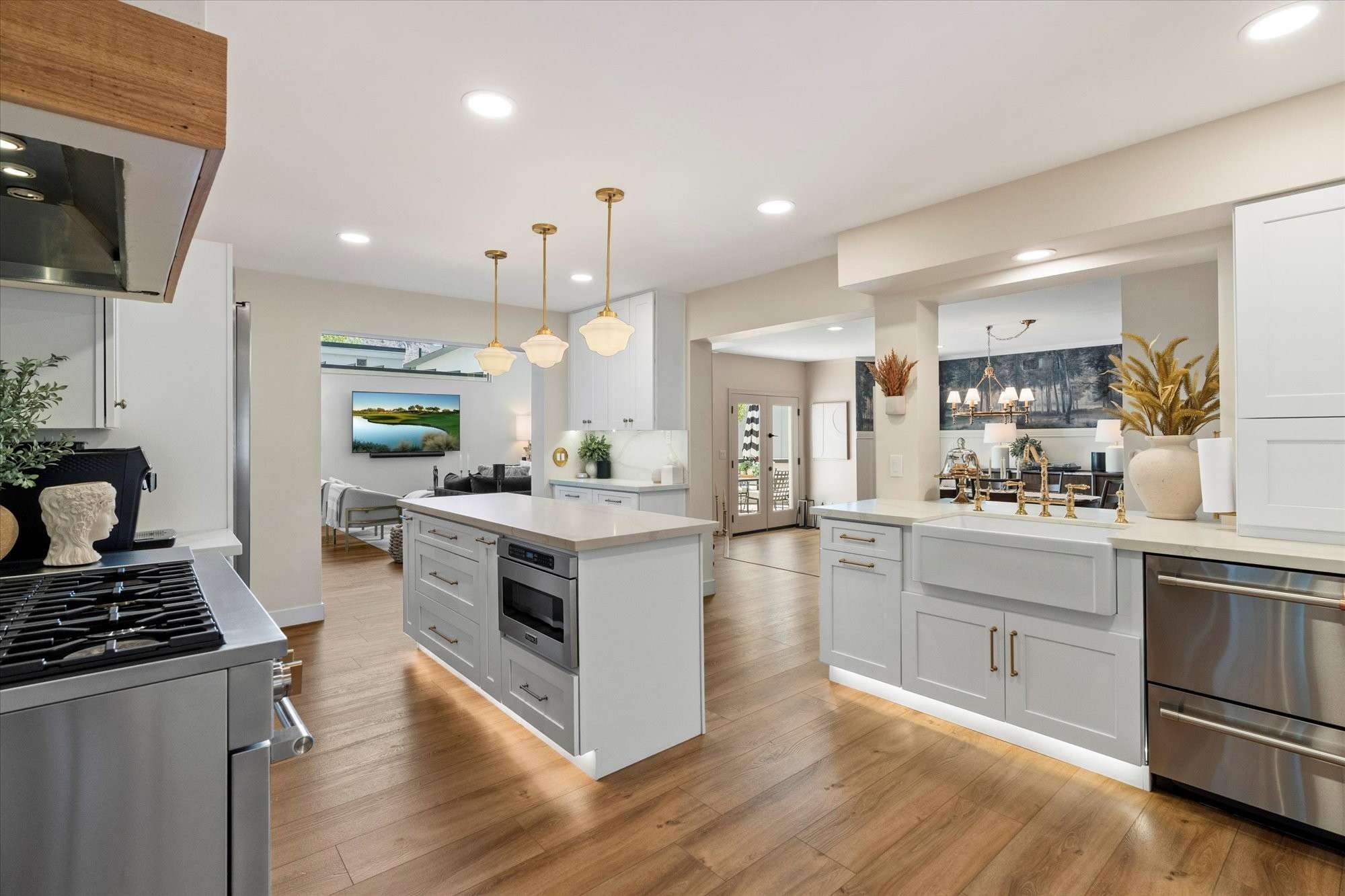 4 of 48. High-end kitchen showcasing dual islands, custom cabinetry, statement lighting, and premium finishes ideal for entertaining in Arcadia.